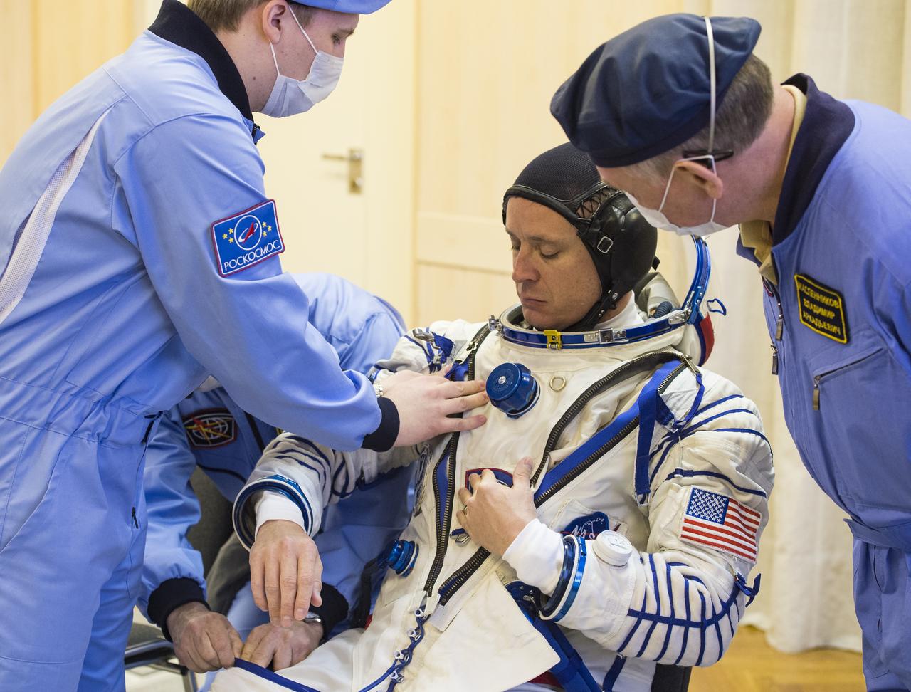 Expedition 51 Flight Engineer Jack Fischer of NASA is helped into his Russian Sokol suit as he and fellow crewmate, Soyuz Commander Fyodor Yurchikhin of Roscosmos prepare for their Soyuz launch to the International Space Station, Thursday, April 20, 2017 at the Baikonur Cosmodrome in Kazakhstan. Launch of the Soyuz rocket is scheduled for 1:13pm April 20 Baikonur time, and will carry Fischer and Yurchikhin into orbit to begin their four and a half month mission on the International Space Station. Photo Credit: (GCTC/Andrey Shelepin)