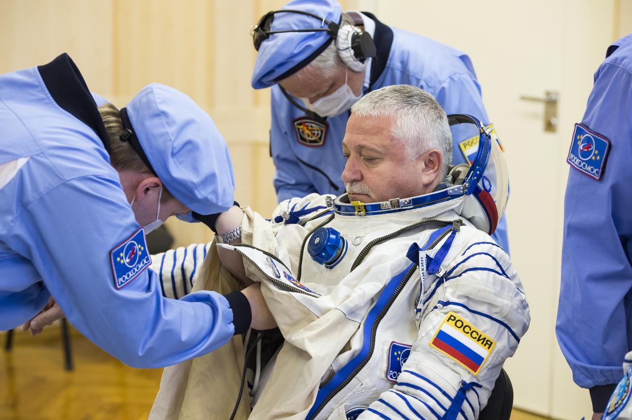 Expedition 51 Soyuz Commander Fyodor Yurchikhin of Roscosmos is helped into his Russian Sokol suit as he and fellow crewmate Flight Engineer Jack Fischer of NASA prepare for their Soyuz launch to the International Space Station, on Thursday, April 20, 2017 at the Baikonur Cosmodrome in Kazakhstan. Launch of the Soyuz rocket is scheduled for 1:13 p.m. April 20 Baikonur time, and will carry Yurchikhin and Fischer into orbit to begin their four and a half month mission on the International Space Station. Photo Credit: (GCTC/Andrey Shelepin)