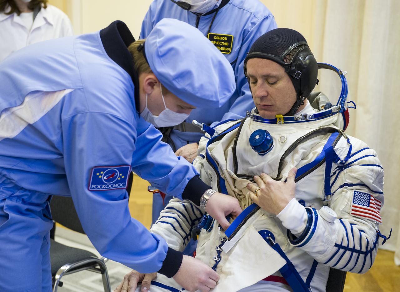 Expedition 51 Flight Engineer Jack Fischer of NASA is helped into his Russian Sokol suit as he and fellow crewmate, Soyuz Commander Fyodor Yurchikhin of Roscosmos prepare for their Soyuz launch to the International Space Station, on Thursday, April 20, 2017 at the Baikonur Cosmodrome in Kazakhstan. Launch of the Soyuz rocket is scheduled for 1:13p.m. April 20 Baikonur time, and will carry Fischer and Yurchikhin into orbit to begin their four and a half month mission on the International Space Station. Photo Credit: (GCTC/Andrey Shelepin)