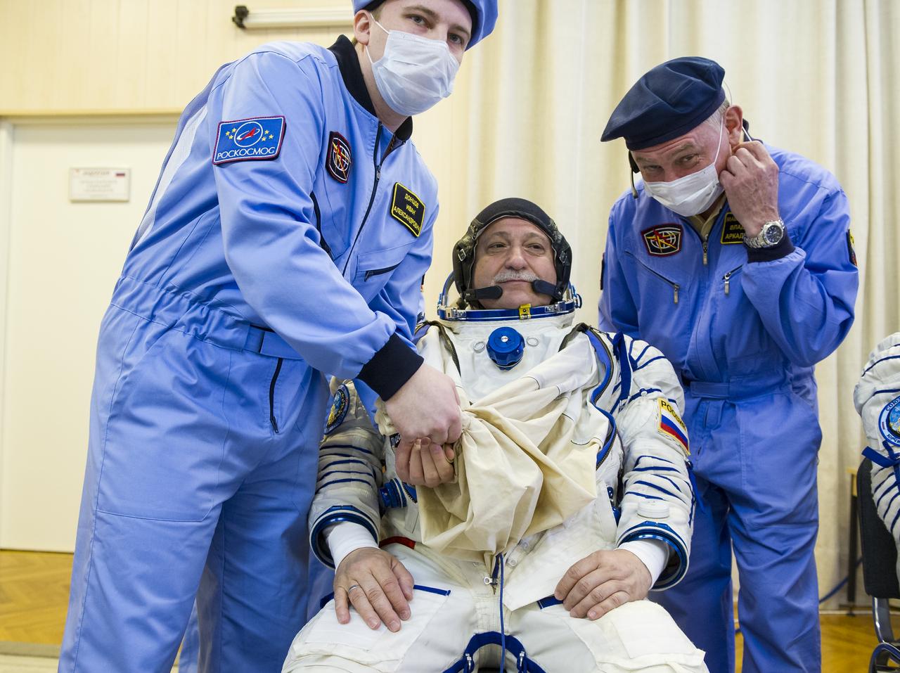 Expedition 51 Soyuz Commander Fyodor Yurchikhin of Roscosmos is helped into his Russian Sokol suit as he and fellow crewmate, Flight Engineer Jack Fischer of NASA prepare for their Soyuz launch to the International Space Station, on Thursday, April 20, 2017 at the Baikonur Cosmodrome in Kazakhstan. Launch of the Soyuz rocket is scheduled for 1:13 p.m. April 20 Baikonur time, and will carry Yurchikhin and Fischer into orbit to begin their four and a half month mission on the International Space Station. Photo Credit: (GCTC/Andrey Shelepin)