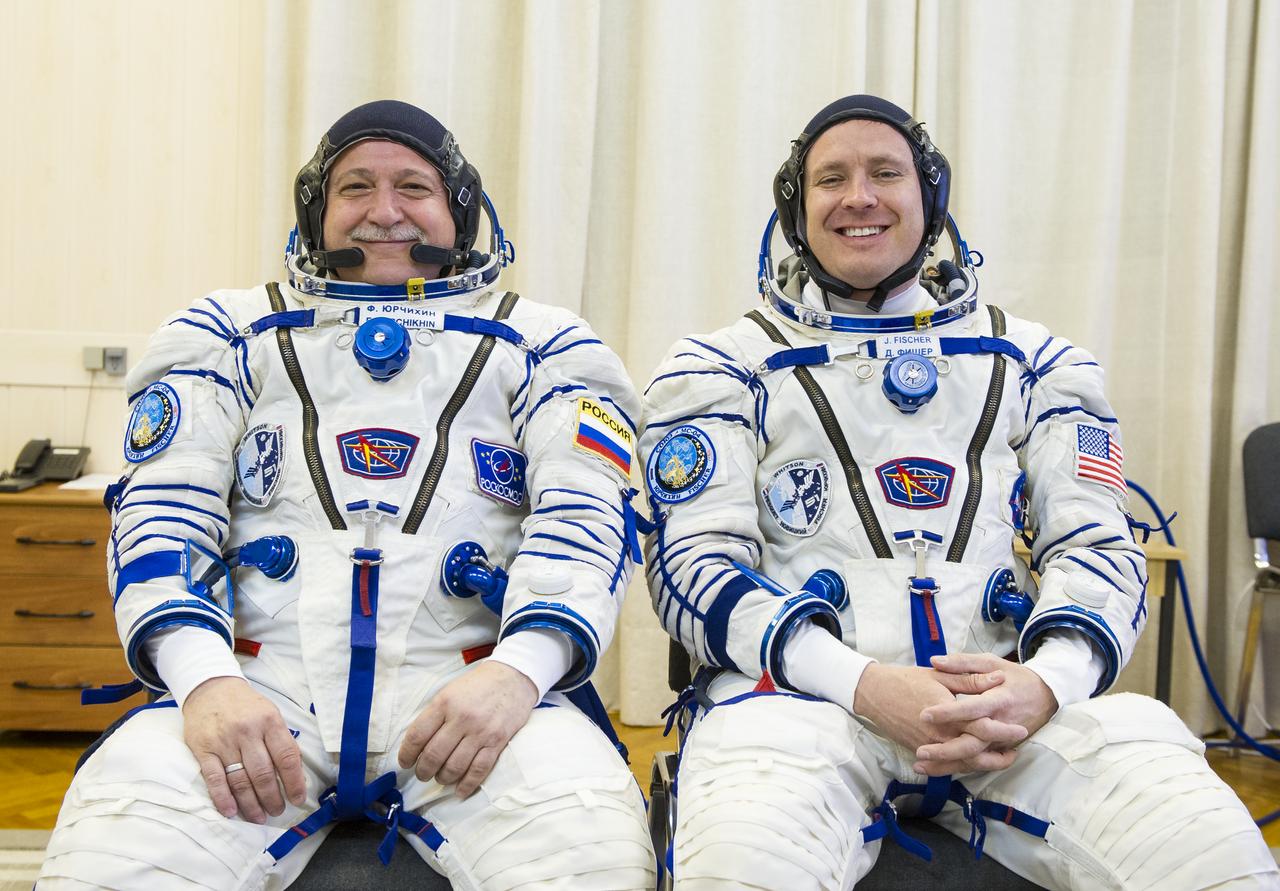 Expedition 51 Soyuz Commander Fyodor Yurchikhin of Roscosmos, left, and Flight Engineer Jack Fischer of NASA, right, pose for a photo after being helped into their Russian Sokol suits in preparation for their Soyuz launch to the International Space Station, on Thursday, April 20, 2017 at the Baikonur Cosmodrome in Kazakhstan. Launch of the Soyuz rocket is scheduled for 1:13 p.m. April 20 Baikonur time, and will carry Yurchikhin and Fischer into orbit to begin their four and a half month mission on the International Space Station. Photo Credit: (GCTC/Andrey Shelepin)