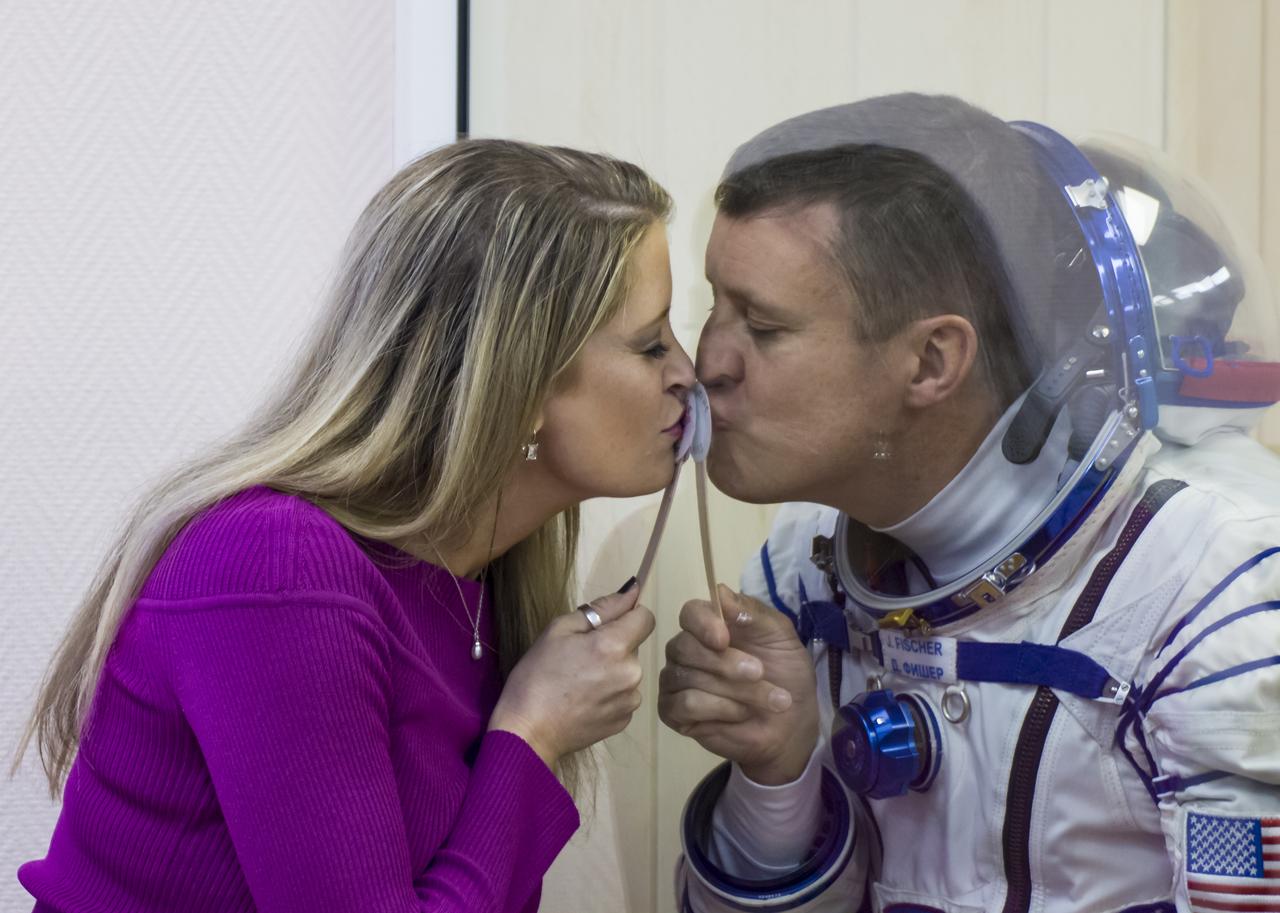 Expedition 51 Flight Engineer Jack Fischer of NASA gives his wife Elizabeth a kiss through glass while in quarantine, after having his Russian Sokol suit pressure checked in preparation for launch onboard the Soyuz MS-04 spacecraft on Thursday, April 20, 2017 at the Baikonur Cosmodrome in Kazakhstan. The Soyuz spacecraft with Fischer and Soyuz Commander Fyodor Yurchikhin of Roscosmos is scheduled to launch at 1:13 p.m. Baikonur time on April 20. Photo Credit: (NASA/Victor Zelentsov)