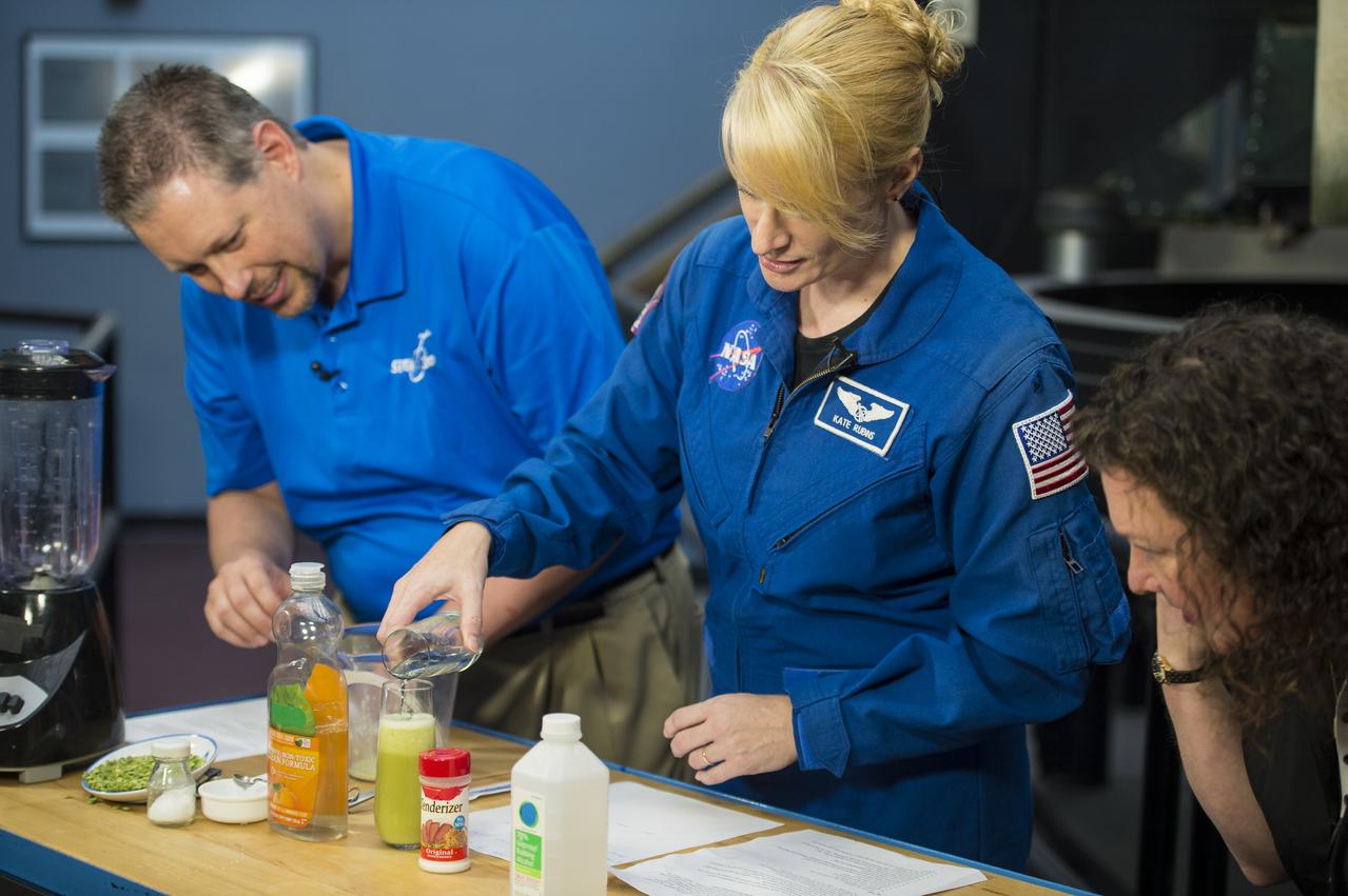 NASA Astronaut Kate Rubins conducts a DNA experiment for a STEM in 30 segment, Thursday, April 27, 2017 at Smithsonian's National Air and Space Museum in Washington. Rubins served on the International Space Station during Expeditions 48 and 49 and became the first person to sequence DNA in space. She completed her first mission when she landed in a remote area near the town of Zhezkazgan, Kazakhstan in October 2016. Photo Credit: (NASA/Aubrey Gemignani)