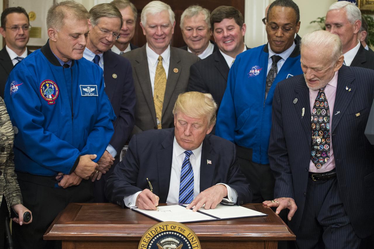 President Donald Trump, center, signs an Executive Order to reestablish the National Space Council, alongside members of the Congress, National Aeronautics and Space Administration, and Commercial Space Companies in the Roosevelt room of the White House in Washington, Friday, June 30, 2017. Vice President Mike Pence, also in attendance, will chair the council. Also pictured are retired NASA astronaut David Wolf, left, NASA Astronaut Alvin Drew, second from right, and retired NASA astronaut Buzz Aldrin, right. Photo Credit: (NASA/Aubrey Gemignani)