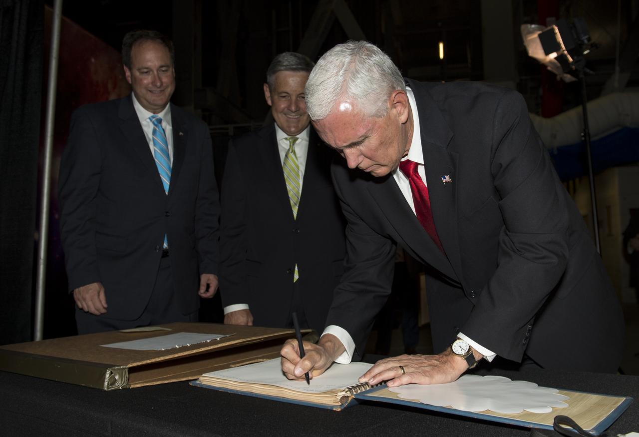 Vice President Mike Pence signs a NASA Kennedy Space Center (KSC) guest book while Acting NASA Administrator, Robert Lightfoot, left, and KSC's director, Robert D. Cabana, center, look on, Thursday, July 6, 2017, in the green room at KSC in Cape Canaveral, Florida. Vice President Mike Pence is scheduled to speak at the event to highlight innovations made in America and tour some of the public/private partnership work that is helping to transform the center into a multi-user spaceport. Photo Credit: (NASA/Aubrey Gemignani)