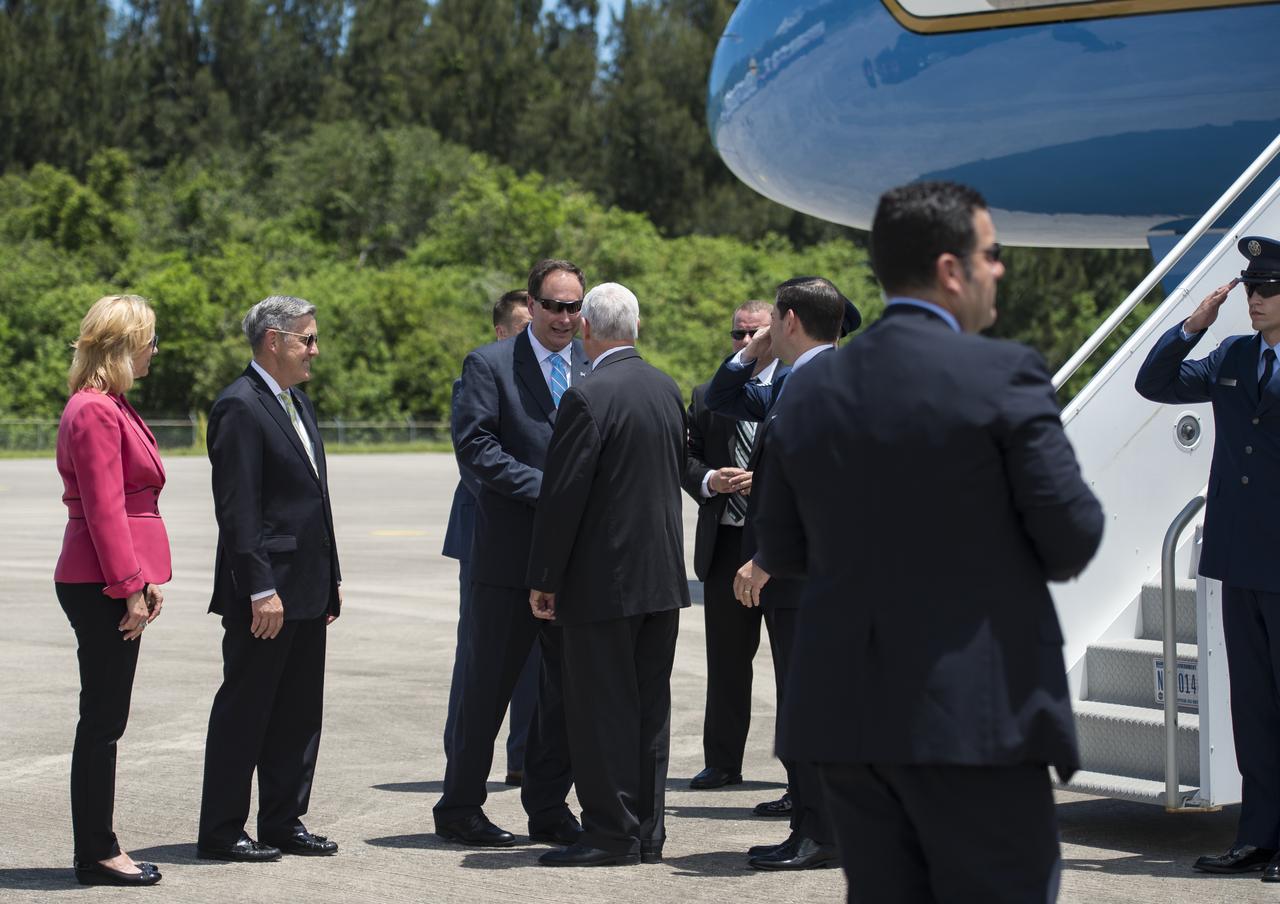 Vice President Mike Pence greets Acting NASA Administrator Robert Lightfoot after arriving at the Shuttle Landing Facility (SLF) to highlight innovations made in America and tour some of the public/private partnership work that is helping to transform Kennedy Space Center (KSC) into a multi-user spaceport on Thursday, July 6, 2017 in Cape Canaveral, Florida. Photo Credit: (NASA/Aubrey Gemignani)