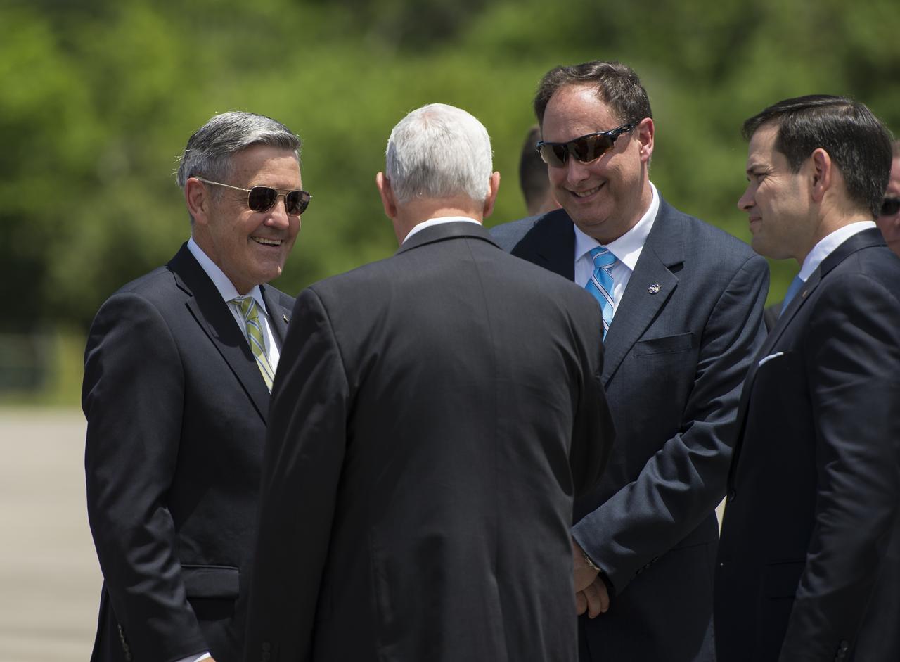 Vice President Mike Pence greets Acting NASA Administrator Robert Lightfoot, second from right, and Director, Kennedy Space Center, Robert Cabana, left, after arriving at the Shuttle Landing Facility (SLF) to highlight innovations made in America and tour some of the public/private partnership work that is helping to transform Kennedy Space Center (KSC) into a multi-user spaceport on Thursday, July 6, 2017 in Cape Canaveral, Florida. Photo Credit: (NASA/Aubrey Gemignani)