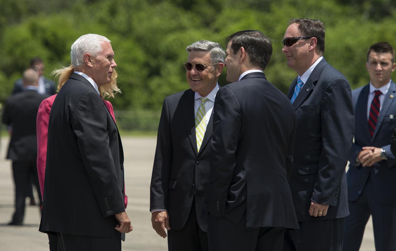 Vice President Mike Pence, left, greets Acting NASA Administrator Robert Lightfoot, right, and Director, Kennedy Space Center, Robert Cabana, second from left, with U.S. Senator Marco Rubio, center, after arriving at the Shuttle Landing Facility (SLF) to highlight innovations made in America and tour some of the public/private partnership work that is helping to transform Kennedy Space Center (KSC) into a multi-user spaceport on Thursday, July 6, 2017 in Cape Canaveral, Florida. Photo Credit: (NASA/Aubrey Gemignani)