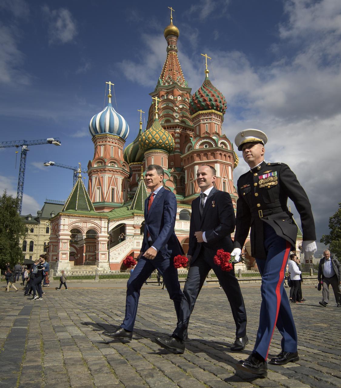 Expedition 52 flight engineers Paolo Nespoli of ESA, left, Sergey Ryazanskiy of Roscosmos, center, and Randy Bresnik of NASA visit Red Square to lay roses at the site where Russian space icons are interred as part of traditional pre-launch ceremonies, Monday, July 10, 2017 in Moscow. Photo Credit: (NASA/Bill Ingalls)