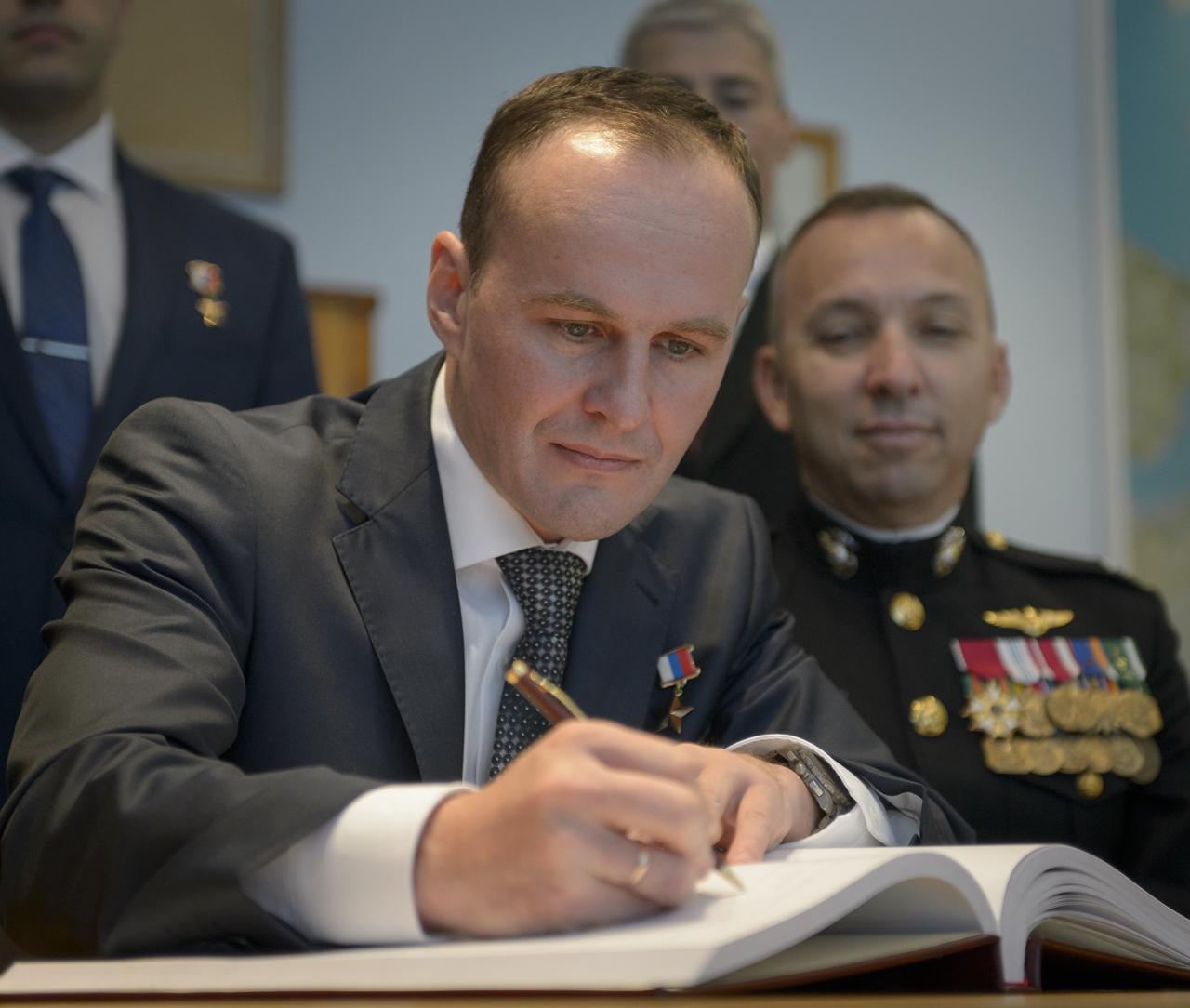 Expedition 52 flight engineers Sergey Ryazanskiy of Roscosmos, seated left, and Randy Bresnik of NASA are seen as they sign a guest book at the "Memorial working study of Yuri Gagarin" at the Gagarin Cosmonaut Training Center (GCTC), Monday, July 10, 2017 in Star City, Russia. The memorial study represents Gagarin's working study in the way it was abandoned by Gagarin on March 27, 1968 before leaving for the airfield for training flight that became his last. Photo Credit: (NASA/Bill Ingalls)