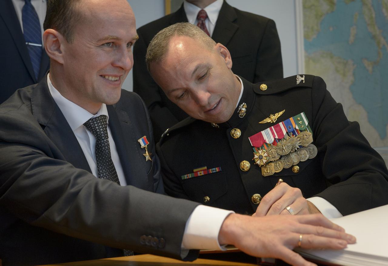 Expedition 52 flight engineers Sergey Ryazanskiy of Roscosmos, seated left, and Randy Bresnik of NASA are seen as they sign a guest book at the "Memorial working study of Yuri Gagarin" at the Gagarin Cosmonaut Training Center (GCTC), Monday, July 10, 2017 in Star City, Russia. The memorial study represents Gagarin's working study in the way it was abandoned by Gagarin on March 27, 1968 before leaving for the airfield for training flight that became his last. Photo Credit: (NASA/Bill Ingalls)