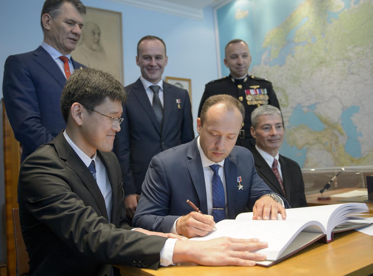 Expedition 52 backup crew members, Norishige Kanai, seated left, Alexander Misurkin, and Mark Vande Hei, seated right, sign a guest book at the "Memorial working study of Yuri Gagarin" at the Gagarin Cosmonaut Training Center (GCTC) as Expedition 52 flight engineers Paolo Nespoli of ESA, standing left, Sergey Ryazanskiy of Roscosmos, center, and Randy Bresnik of NASA, look on, Monday, July 10, 2017 in Star City, Russia. The memorial study represents Gagarin's working study in the way it was abandoned by Gagarin on March 27, 1968 before leaving for the airfield for training flight that became his last. Photo Credit: (NASA/Bill Ingalls)