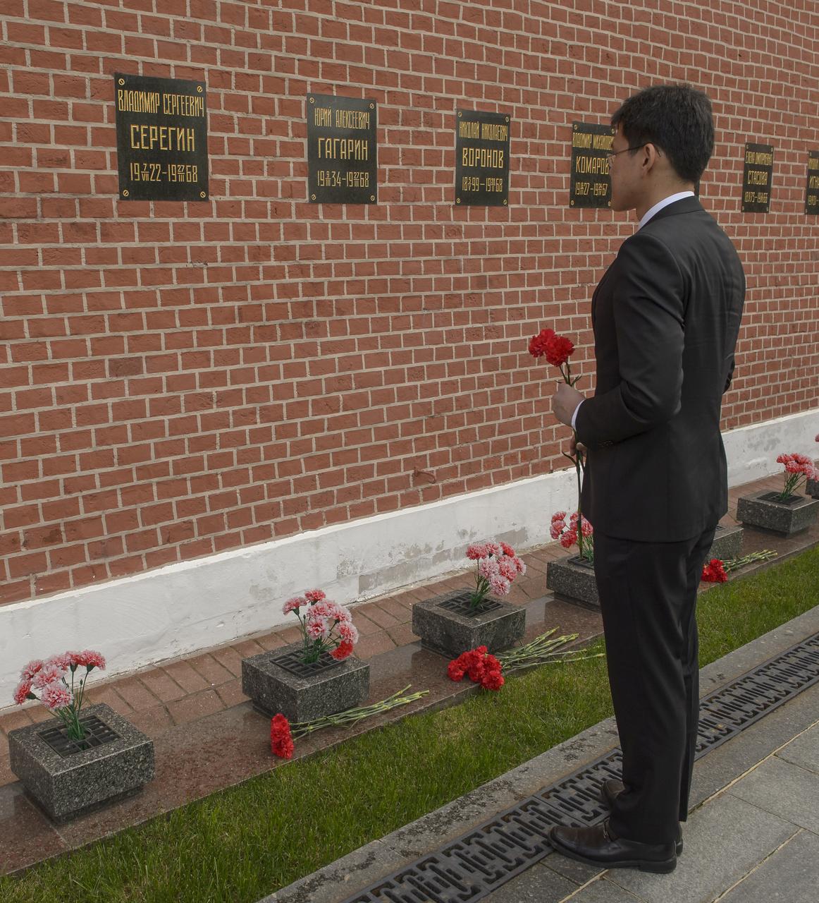 Expedition 52 backup crew member Norishige Kanai of the Japan Aerospace Exploration Agency (JAXA) lays roses at the site where Russian space icons are interred as part of traditional pre-launch ceremonies, Monday, July 10, 2017 in Moscow. Photo Credit: (NASA/Bill Ingalls)