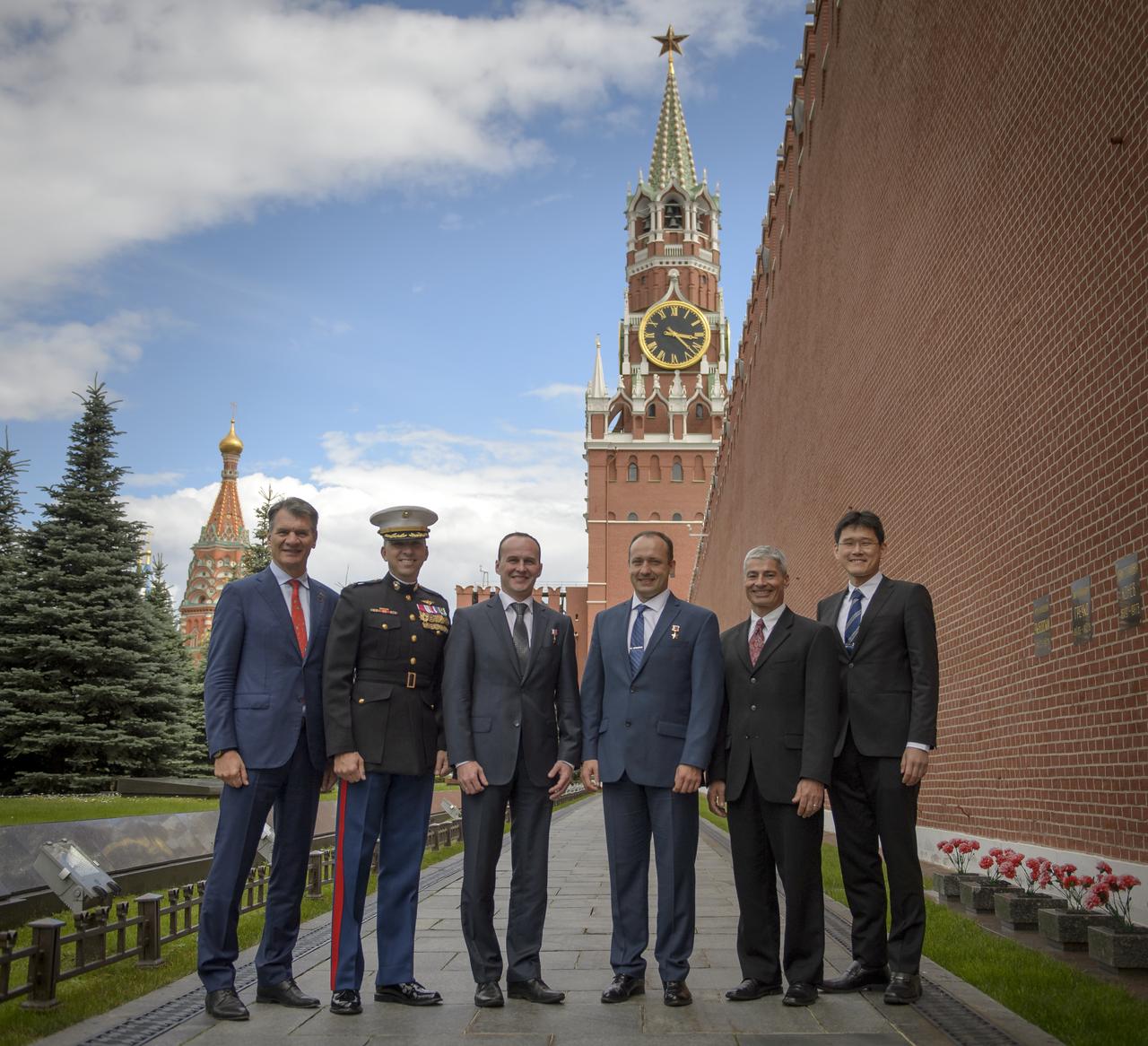 Expedition 52 flight engineers Paolo Nespoli of ESA, left, Randy Bresnik of NASA, Sergey Ryazanskiy of Roscosmos, and backup crew members, Alexander Misurkin of Roscosmos, Mark Vande Hei of NASA, and Norishige Kanai of the Japan Aerospace Exploration Agency (JAXA), right, pose for a group photograph in Red Square after having laid roses at the site where Russian space icons are interred as part of traditional pre-launch ceremonies, Monday, July 10, 2017 in Moscow. Photo Credit: (NASA/Bill Ingalls)