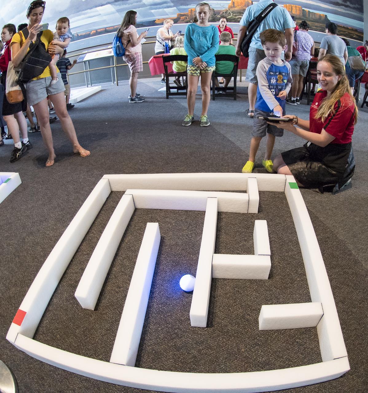 Visitors direct a robotic ball through a maze at the Smithsonian Institution’s National Air and Space Museum Mars Day, an annual event celebrating the Red Planet with exhibits, speakers, and educational activities, Friday, July 21, 2017 in Washington. Photo Credit: (NASA/Aubrey Gemignani)