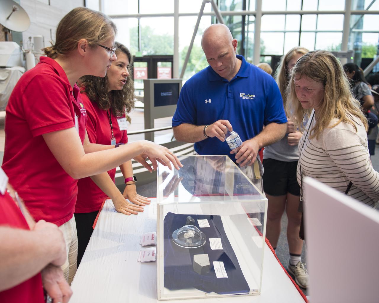 Visitors view a piece of Mars at the Smithsonian Institution’s National Air and Space Museum Mars Day, an annual event celebrating the Red Planet with exhibits, speakers, and educational activities, Friday, July 21, 2017 in Washington. Photo Credit: (NASA/Aubrey Gemignani)