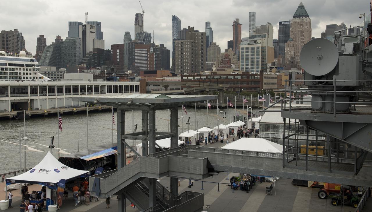 NASA exhibits under white tents line Pier 86 during the Intrepid Space & Science Festival, Saturday, Aug. 5, 2017 held at the Intrepid Sea, Air & Space Museum in New York City. The week-long festival featured talks, films and cutting-edge displays showcasing NASA technology.  Photo Credit: (NASA/Bill Ingalls)