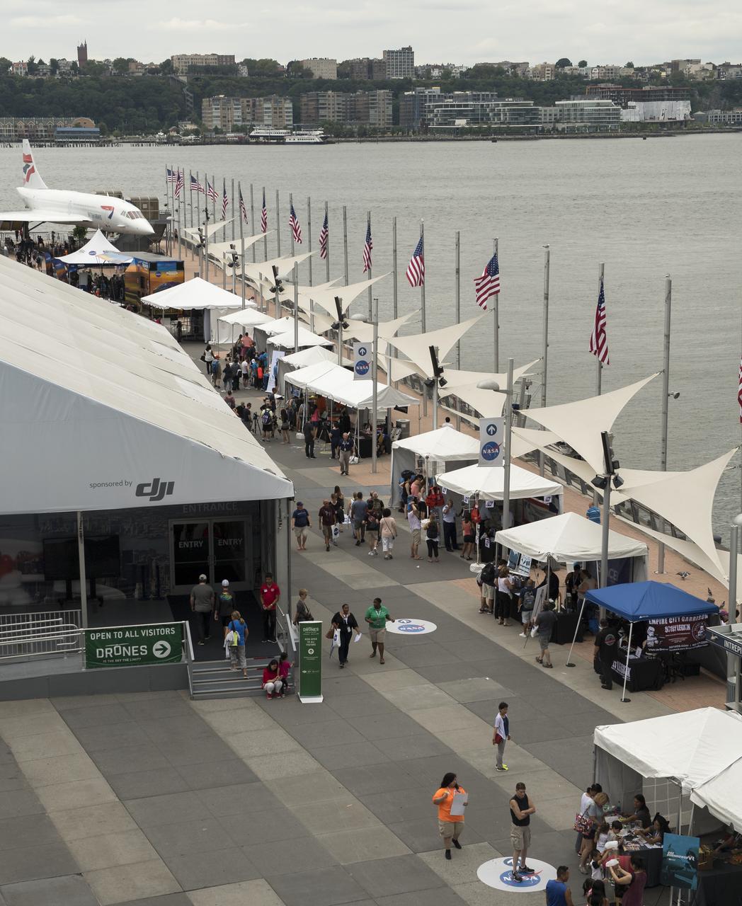 NASA exhibits line Pier 86 during the Intrepid Space & Science Festival, Saturday, Aug. 5, 2017 held at the Intrepid Sea, Air & Space Museum in New York City. The week-long festival featured talks, films and cutting-edge displays showcasing NASA technology. Photo Credit: (NASA/Bill Ingalls)