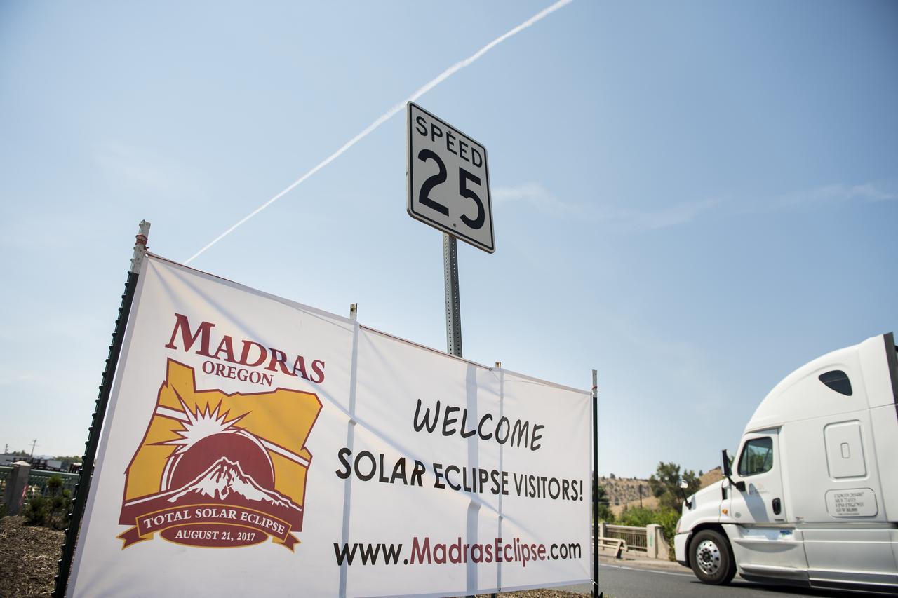A welcome sign is seen along the roads in Madras, Oregon, where thousands of visitors are expected for the total solar eclipse, Saturday, August 19, 2017. The eclipse will be sweeping across a narrow portion of the contiguous United States from Lincoln Beach, Oregon to Charleston, South Carolina on August 21. A partial solar eclipse will be visible across the entire North American continent along with parts of South America, Africa, and Europe.  Photo Credit: (NASA/Aubrey Gemignani)