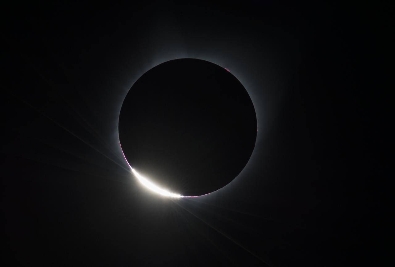 The Diamond Ring  effect is seen as the moon makes its final move over the sun during the total solar eclipse on Monday, August 21, 2017 above Madras, Oregon. A total solar eclipse swept across a narrow portion of the contiguous United States from Lincoln Beach, Oregon to Charleston, South Carolina. A partial solar eclipse was visible across the entire North American continent along with parts of South America, Africa, and Europe.  Photo Credit: (NASA/Aubrey Gemignani)