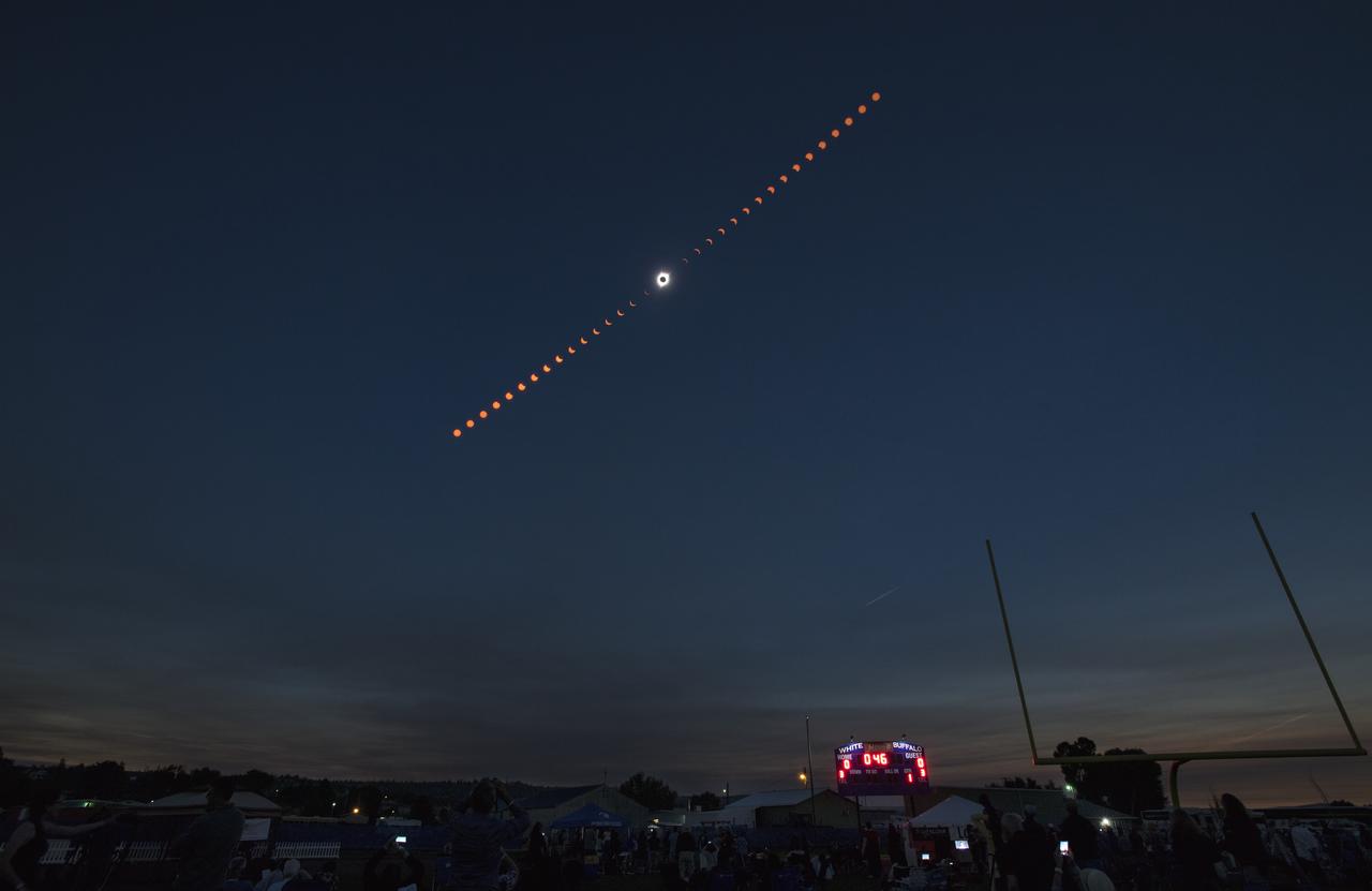 This composite image shows the progression of a total solar eclipse over Madras, Oregon on Monday, Aug. 21, 2017. A total solar eclipse swept across a narrow portion of the contiguous United States from Lincoln Beach, Oregon to Charleston, South Carolina. A partial solar eclipse was visible across the entire North American continent along with parts of South America, Africa, and Europe.  Photo Credit: (NASA/Aubrey Gemignani)