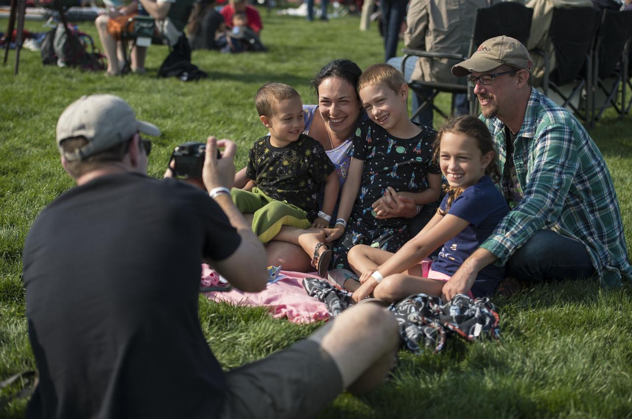 The Vasquez family from Eureka and Edgewood, Washington take a photo during the total solar eclipse in Madras, Oregon on Monday, Aug. 21, 2017. A total solar eclipse swept across a narrow portion of the contiguous United States from Lincoln Beach, Oregon to Charleston, South Carolina. A partial solar eclipse was visible across the entire North American continent along with parts of South America, Africa, and Europe.  Photo Credit: (NASA/Aubrey Gemignani)