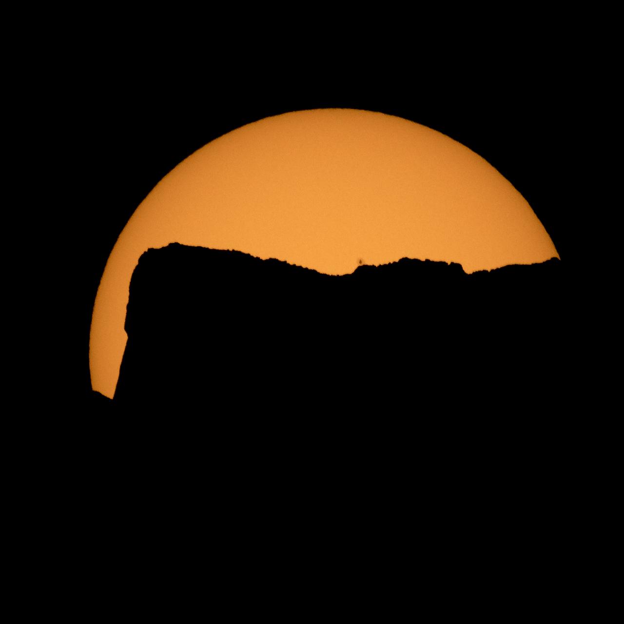 The Sun is seen as it rises behind Jack Mountain head of the solar eclipse, Monday, Aug. 21, 2017, Ross Lake, Northern Cascades National Park, Washington. A total solar eclipse will sweep across a narrow portion of the contiguous United States from Lincoln Beach, Oregon to Charleston, South Carolina. A partial solar eclipse was visible across the entire North American continent along with parts of South America, Africa, and Europe.  Photo Credit: (NASA/Bill Ingalls)