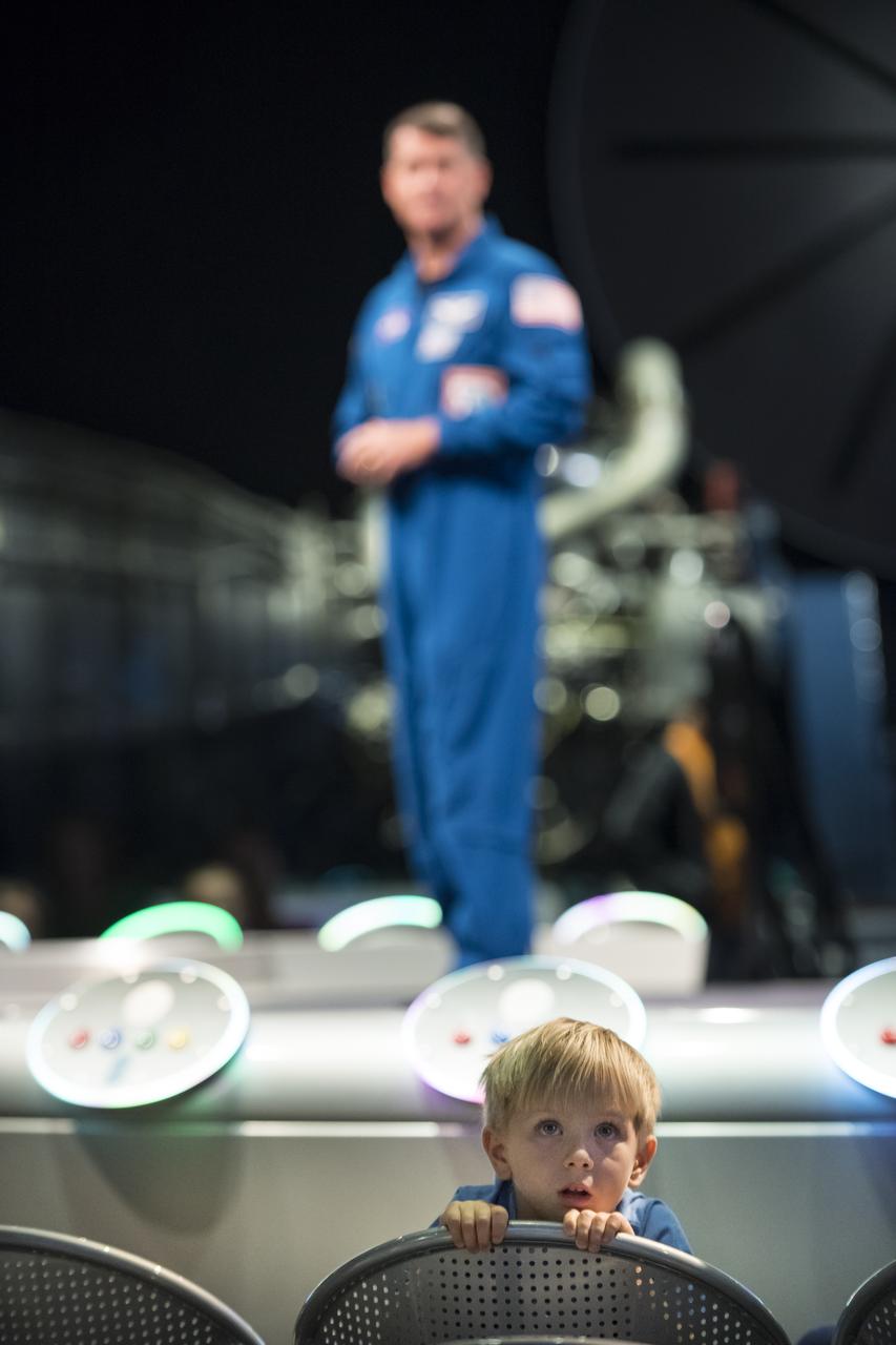 A young audience member listens while NASA astronaut Shane Kimbrough speaks about his time onboard the International Space Station (ISS) during Expeditions 49/50, Tuesday, September 12, 2017 at Smithsonian's National Air and Space Museum in Washington. During Expedition 50, Kimbrough completed four spacewalks for a total of 39 hours outside the ISS, and concluded his 173-day mission when he landed in a remote area near the town of Zhezkazgan, Kazakhstan in April 2017. Photo Credit: (NASA/Aubrey Gemignani)
