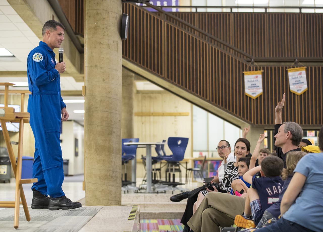 Audience members raise their hands to ask NASA astronaut Shane Kimbrough a question about his time onboard the International Space Station (ISS) during Expeditions 49/50, Tuesday, September 12, 2017 at Arlington Career Center in Arlington, Virginia. During Expedition 50, Kimbrough completed four spacewalks for a total of 39 hours outside the ISS, and concluded his 173-day mission when he landed in a remote area near the town of Zhezkazgan, Kazakhstan in April 2017. Photo Credit: (NASA/Aubrey Gemignani)