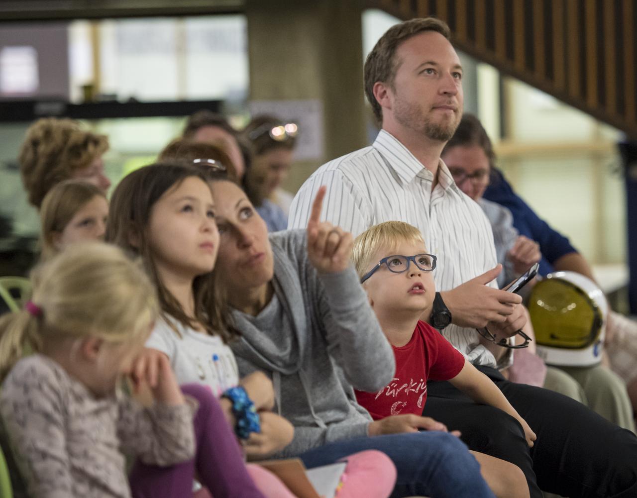 Audience members watch a live broadcast of Expedition 53 crew launching on the Soyuz rocket to the International Space Station during a presentation by Expedition 49/50 NASA astronaut Shane Kimbrough, Tuesday, September 12, 2017 at Arlington Career Center in Arlington, Virginia. During Expedition 50, Kimbrough completed four spacewalks for a total of 39 hours outside the ISS, and concluded his 173-day mission when he landed in a remote area near the town of Zhezkazgan, Kazakhstan in April 2017. Photo Credit: (NASA/Aubrey Gemignani)