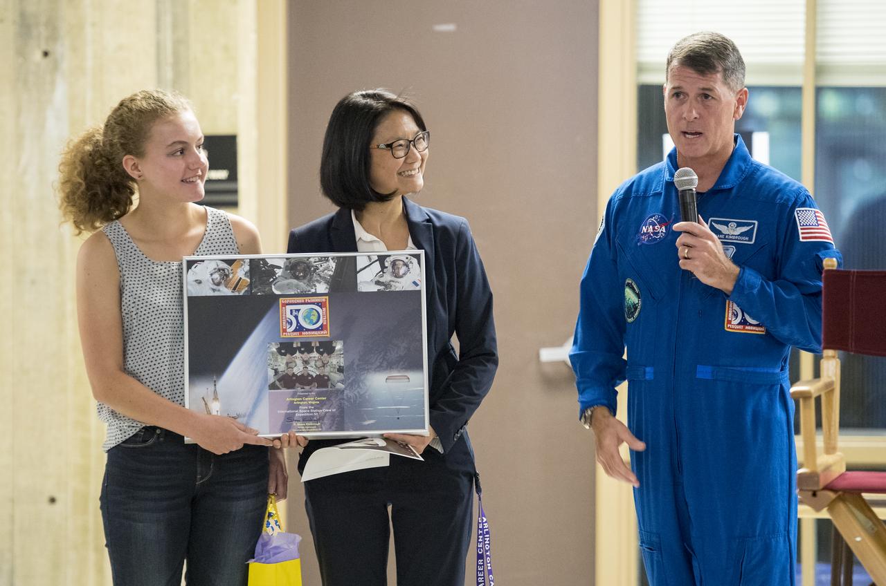 NASA astronaut Shane Kimbrough presents a montage of photos and the Expedition 50 patch to the Arlington Tech High School who hosted his presentation on his time onboard the International Space Station (ISS) during Expeditions 49/50, Tuesday, September 12, 2017 at Arlington Career Center in Arlington, Virginia. During Expedition 50, Kimbrough completed four spacewalks for a total of 39 hours outside the ISS, and concluded his 173-day mission when he landed in a remote area near the town of Zhezkazgan, Kazakhstan in April 2017. Photo Credit: (NASA/Aubrey Gemignani)