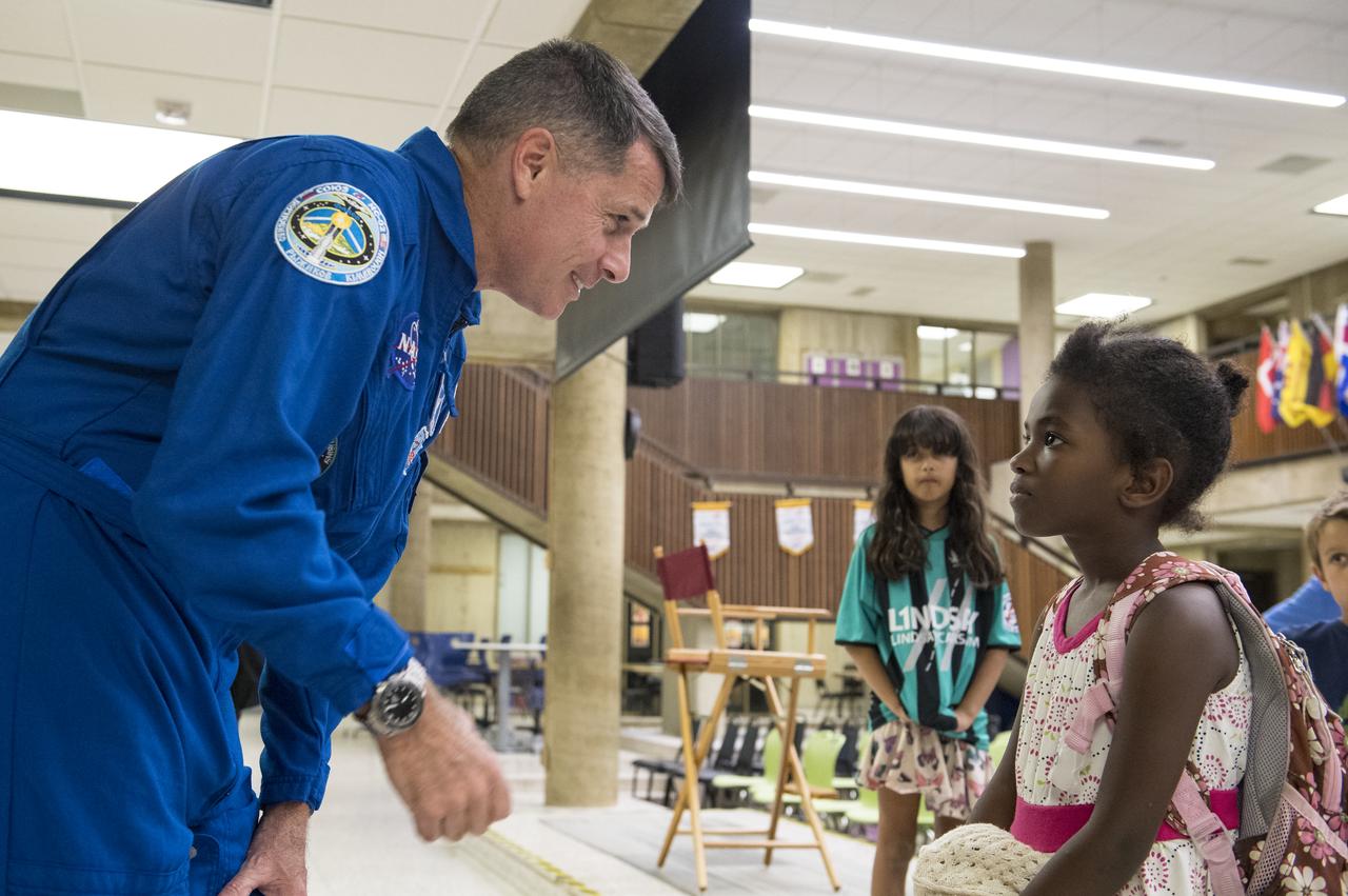 NASA astronaut Shane Kimbrough speaks to an audience member after giving a presentation about his time onboard the International Space Station (ISS) during Expeditions 49/50, Tuesday, September 12, 2017 at Arlington Career Center in Arlington, Virginia. During Expedition 50, Kimbrough completed four spacewalks for a total of 39 hours outside the ISS, and concluded his 173-day mission when he landed in a remote area near the town of Zhezkazgan, Kazakhstan in April 2017. Photo Credit: (NASA/Aubrey Gemignani)