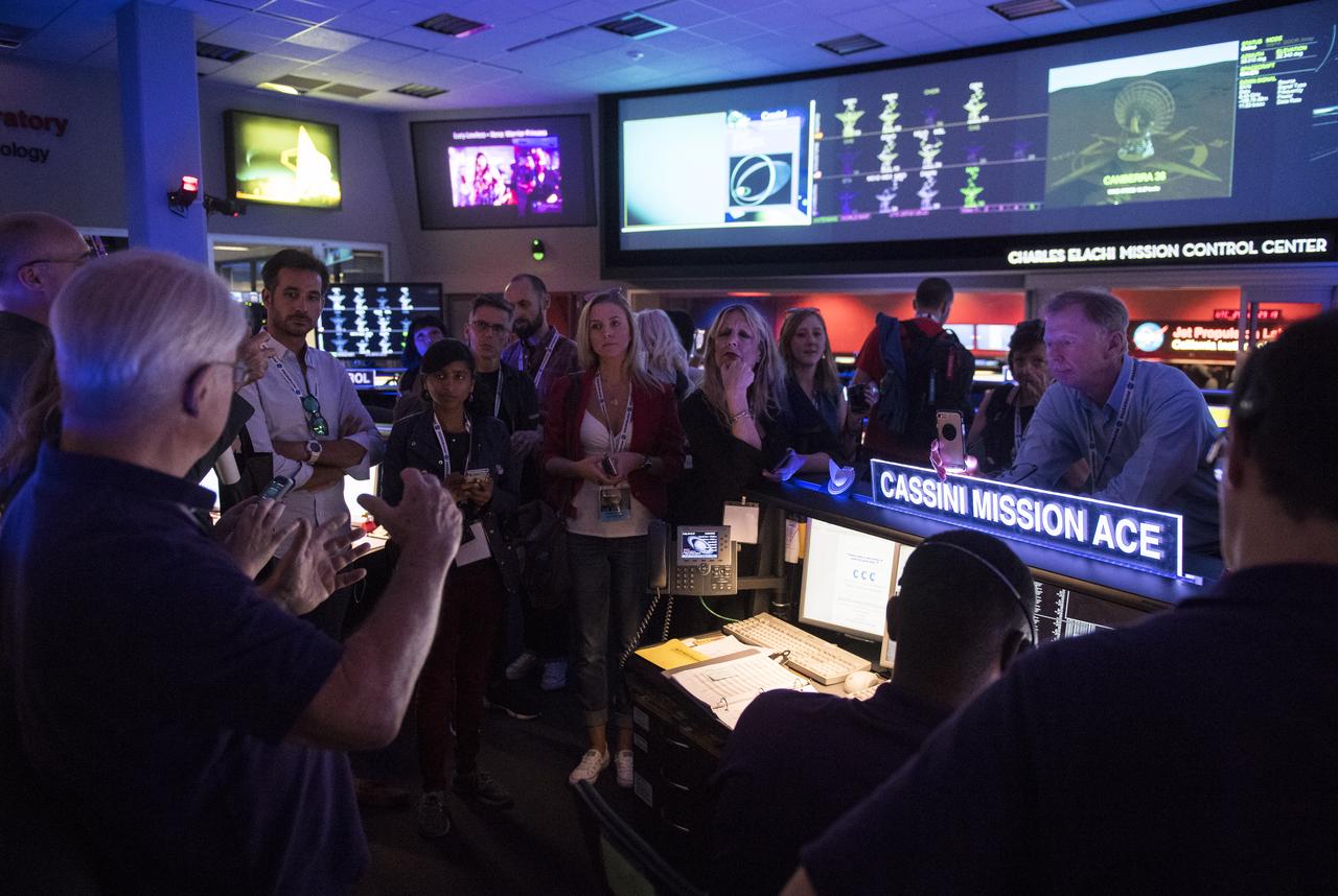 Cassini NASA Social attendees speak with members of the Cassini mission team in the Charles Elachi Mission Control Center in the Space Flight Operation Center, Thursday, Sept. 14, 2017 at NASA's Jet Propulsion Laboratory in Pasadena, California. Since its arrival in 2004, the Cassini-Huygens mission has been a discovery machine, revolutionizing our knowledge of the Saturn system and captivating us with data and images never before obtained with such detail and clarity. On Sept. 15, 2017, operators will deliberately plunge the spacecraft into Saturn, as Cassini gathered science until the end. The “plunge” ensures Saturn’s moons will remain pristine for future exploration. During Cassini’s final days, mission team members from all around the world gathered at NASA’s Jet Propulsion Laboratory, Pasadena, California, to celebrate the achievements of this historic mission. Photo Credit: (NASA/Joel Kowsky)
