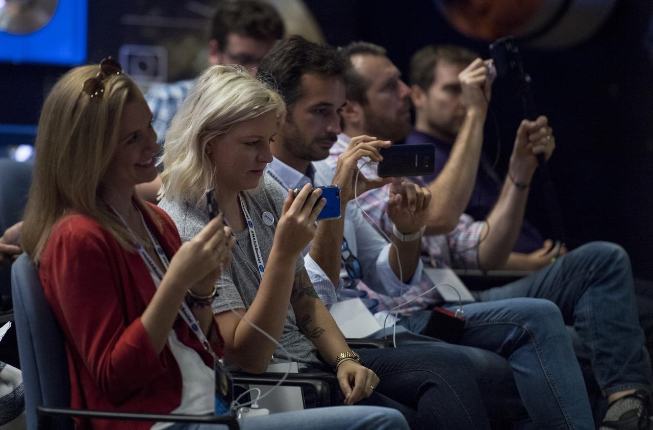 NASA Social attendees are seen during a science panel discussion with Cassini project scientist at JPL, Linda Spilker, Cassini interdisciplinary Titan scientist at Cornell University, Jonathan Lunine, Cassini Composite Infrared Spectrometer(CIRS) Instrument deputy principle investigator Connor Nixon, and Cassini assistant project science systems engineer Morgan Cable, Thursday, Sept. 14, 2017 at NASA's Jet Propulsion Laboratory in Pasadena, California. Since its arrival in 2004, the Cassini-Huygens mission has been a discovery machine, revolutionizing our knowledge of the Saturn system and captivating us with data and images never before obtained with such detail and clarity. On Sept. 15, 2017, operators will deliberately plunge the spacecraft into Saturn, as Cassini gathered science until the end. The “plunge” ensures Saturn’s moons will remain pristine for future exploration. During Cassini’s final days, mission team members from all around the world gathered at NASA’s Jet Propulsion Laboratory, Pasadena, California, to celebrate the achievements of this historic mission. Photo Credit: (NASA/Joel Kowsky)