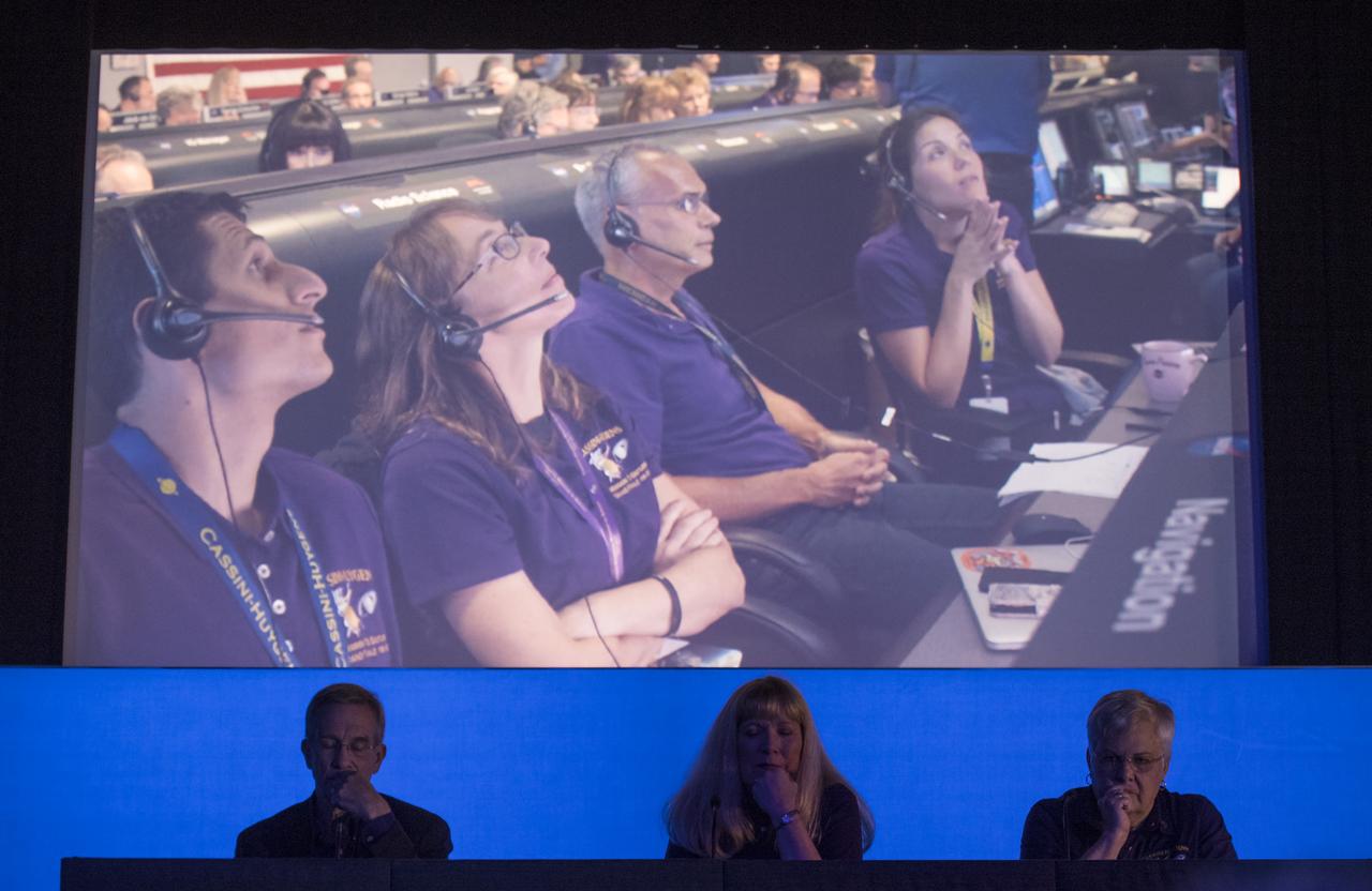Cassini program manager at JPL, Earl Maize, left, Cassini project scientist at JPL, Linda Spilker, center, and spacecraft operations team manager for the Cassini mission at Saturn, Julie Webster, right, are seen as they watch a replay of the final moments of the Cassini spacecraft during a press conference held after the end of the Cassini mission, Friday, Sept. 15, 2017 at NASA's Jet Propulsion Laboratory in Pasadena, California. Since its arrival in 2004, the Cassini-Huygens mission has been a discovery machine, revolutionizing our knowledge of the Saturn system and captivating us with data and images never before obtained with such detail and clarity. On Sept. 15, 2017, operators deliberately plunged the spacecraft into Saturn, as Cassini gathered science until the end. Loss of contact with the Cassini spacecraft occurred at 7:55 a.m. EDT (4:55 a.m. PDT). The “plunge” ensures Saturn’s moons will remain pristine for future exploration. During Cassini’s final days, mission team members from all around the world gathered at NASA’s Jet Propulsion Laboratory, Pasadena, California, to celebrate the achievements of this historic mission. Photo Credit: (NASA/Joel Kowsky)