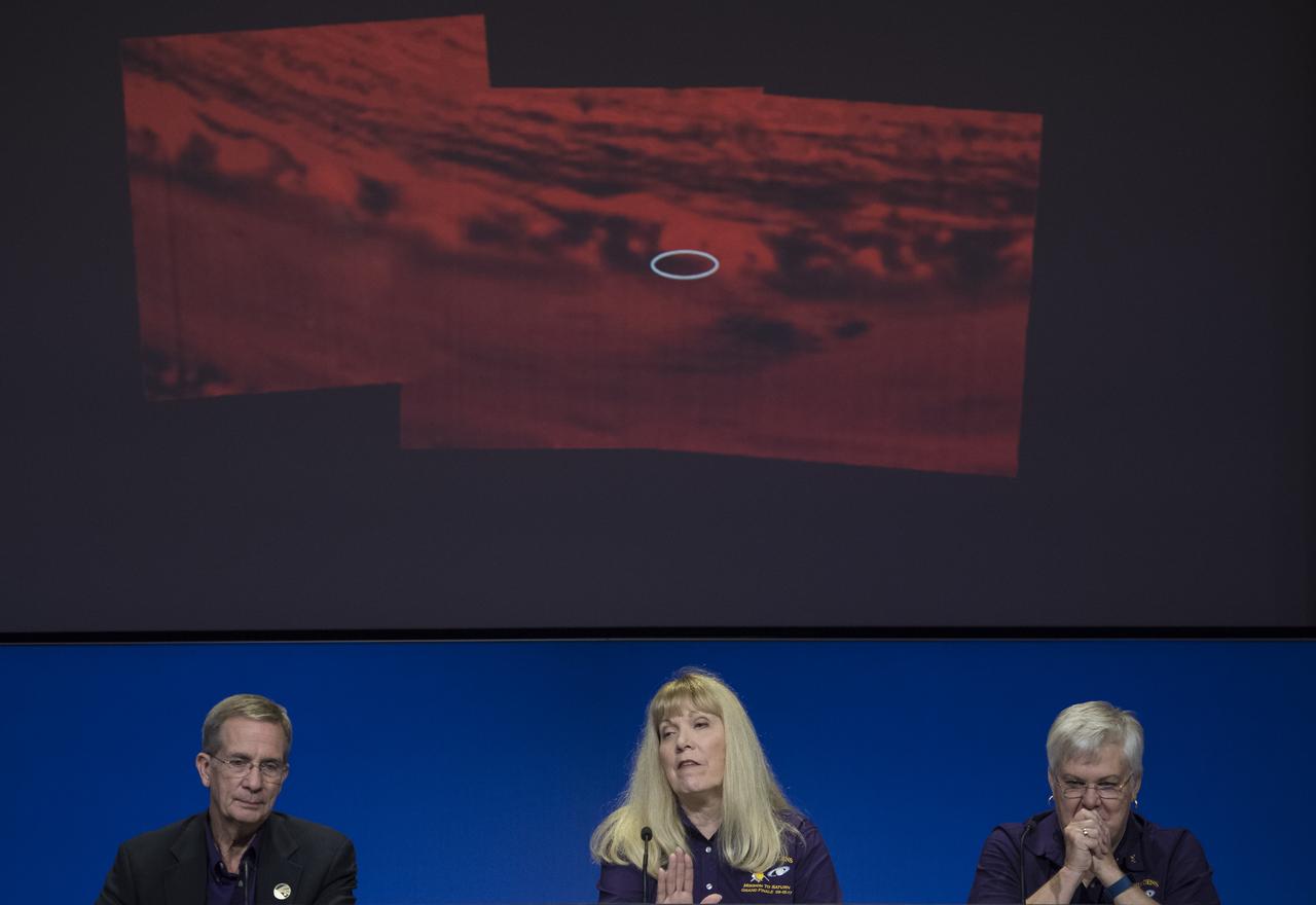 Cassini project scientist at JPL, Linda Spilker, center, speaks about a montage of images, made from data obtained by Cassini's visual and infrared mapping spectrometer, shows the location on Saturn where the NASA spacecraft entered Saturn's atmosphere, Friday, Sept. 15, 2017 during a press conference at NASA's Jet Propulsion Laboratory in Pasadena, California. Cassini program manager at JPL, Earl Maize, left, and spacecraft operations team manager for the Cassini mission at Saturn, Julie Webster, right, also participated in the press conference. Since its arrival in 2004, the Cassini-Huygens mission has been a discovery machine, revolutionizing our knowledge of the Saturn system and captivating us with data and images never before obtained with such detail and clarity. On Sept. 15, 2017, operators deliberately plunged the spacecraft into Saturn, as Cassini gathered science until the end. Loss of contact with the Cassini spacecraft occurred at 7:55 a.m. EDT (4:55 a.m. PDT). The “plunge” ensures Saturn’s moons will remain pristine for future exploration. During Cassini’s final days, mission team members from all around the world gathered at NASA’s Jet Propulsion Laboratory, Pasadena, California, to celebrate the achievements of this historic mission. Photo Credit: (NASA/Joel Kowsky)