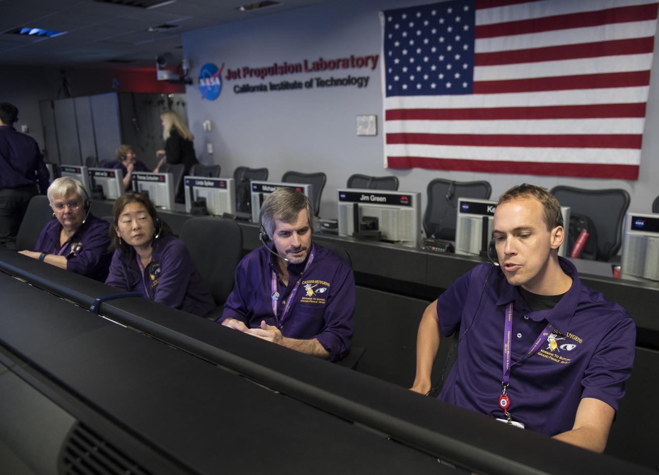 Todd Brown, right, working Cassini's attitude and articulation control subsystems, is seen at his console during the spacecraft's final plunge into Saturn, Friday, Sept. 15, 2017 at NASA's Jet Propulsion Laboratory in Pasadena, California. Since its arrival in 2004, the Cassini-Huygens mission has been a discovery machine, revolutionizing our knowledge of the Saturn system and captivating us with data and images never before obtained with such detail and clarity. On Sept. 15, 2017, operators deliberately plunged the spacecraft into Saturn, as Cassini gathered science until the end. Loss of contact with the Cassini spacecraft occurred at 7:55 a.m. EDT (4:55 a.m. PDT). The “plunge” ensures Saturn’s moons will remain pristine for future exploration. During Cassini’s final days, mission team members from all around the world gathered at NASA’s Jet Propulsion Laboratory, Pasadena, California, to celebrate the achievements of this historic mission. Photo Credit: (NASA/Joel Kowsky)