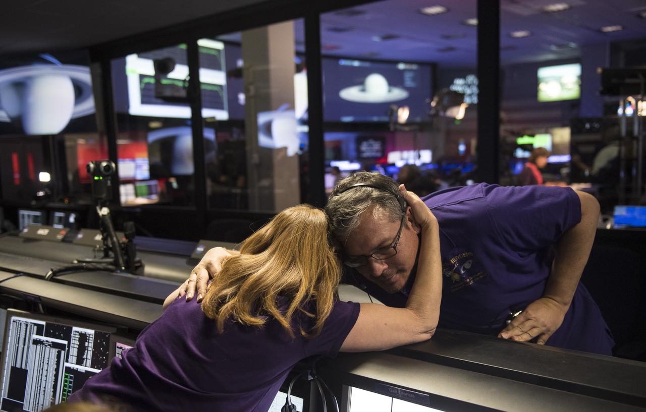 Cassini team members embrace after the spacecraft was deliberately plunged into Saturn, Friday, Sept. 15, 2017 at NASA's Jet Propulsion Laboratory in Pasadena, California. Since its arrival in 2004, the Cassini-Huygens mission has been a discovery machine, revolutionizing our knowledge of the Saturn system and captivating us with data and images never before obtained with such detail and clarity. On Sept. 15, 2017, operators deliberately plunged the spacecraft into Saturn, as Cassini gathered science until the end. Loss of contact with the Cassini spacecraft occurred at 7:55 a.m. EDT (4:55 a.m. PDT) The “plunge” ensures Saturn’s moons will remain pristine for future exploration. During Cassini’s final days, mission team members from all around the world gathered at NASA’s Jet Propulsion Laboratory, Pasadena, California, to celebrate the achievements of this historic mission. Photo Credit: (NASA/Joel Kowsky)