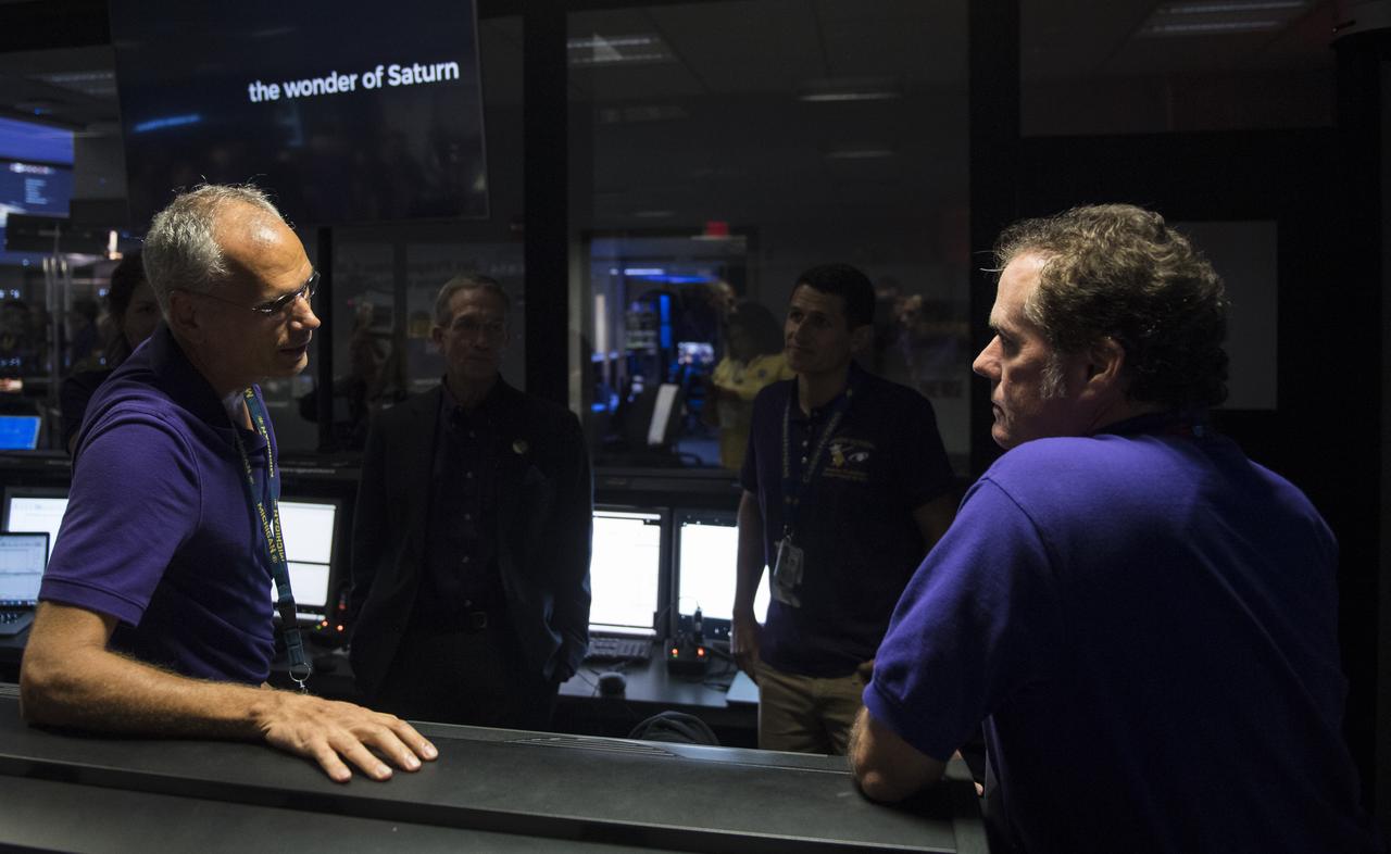 Duane Roth, of Cassini's navigation team, left, speaks with director of NASA's Jet Propulsion Laboratory, Michael Watkins, right, after Cassini's mission was declared over, Friday, Sept. 15, 2017 in mission control at NASA's Jet Propulsion Laboratory in Pasadena, California. Since its arrival in 2004, the Cassini-Huygens mission has been a discovery machine, revolutionizing our knowledge of the Saturn system and captivating us with data and images never before obtained with such detail and clarity. On Sept. 15, 2017, operators deliberately plunged the spacecraft into Saturn, as Cassini gathered science until the end. Loss of contact with the Cassini spacecraft occurred at 7:55 a.m. EDT (4:55 a.m. PDT). The “plunge” ensures Saturn’s moons will remain pristine for future exploration. During Cassini’s final days, mission team members from all around the world gathered at NASA’s Jet Propulsion Laboratory, Pasadena, California, to celebrate the achievements of this historic mission. Photo Credit: (NASA/Joel Kowsky)