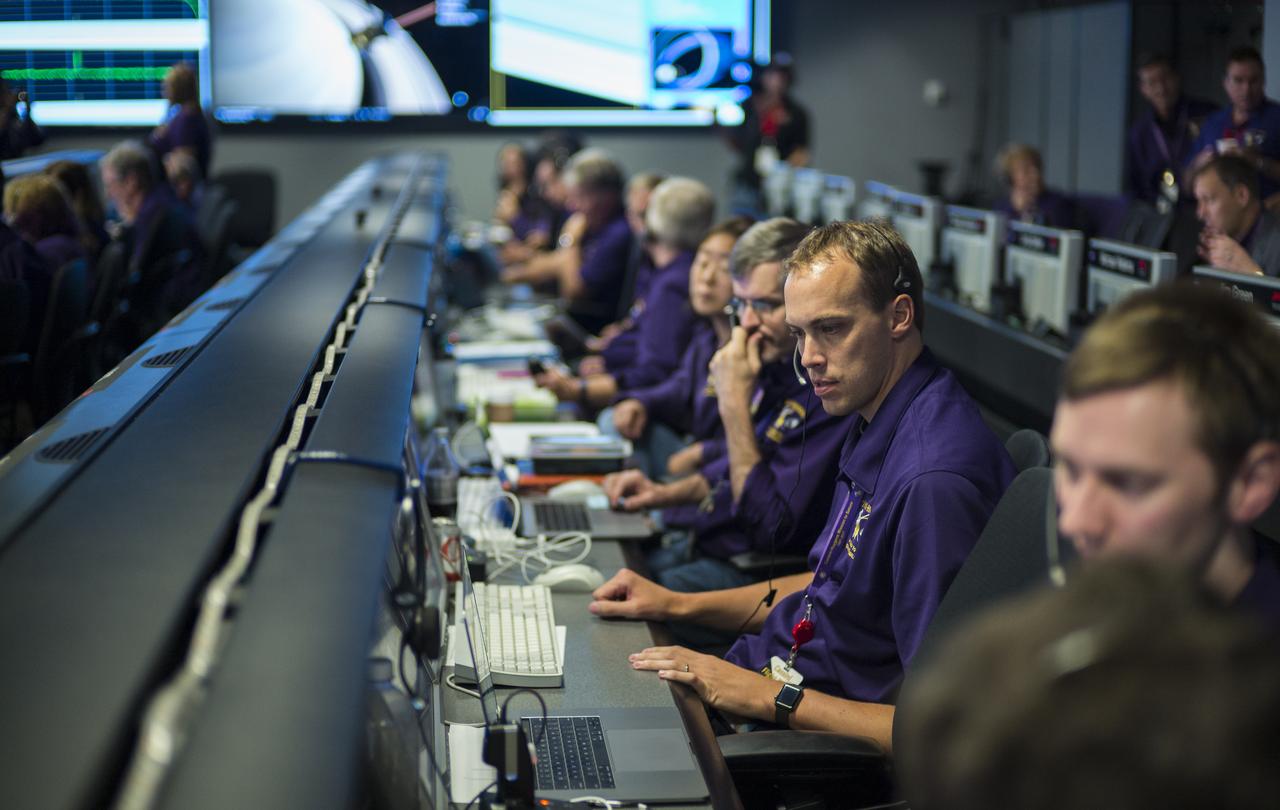 Todd Brown, working Cassini's attitude and articulation control subsystems, is seen at his console during the spacecraft's final plunge into Saturn, Friday, Sept. 15, 2017 at NASA's Jet Propulsion Laboratory in Pasadena, California. Since its arrival in 2004, the Cassini-Huygens mission has been a discovery machine, revolutionizing our knowledge of the Saturn system and captivating us with data and images never before obtained with such detail and clarity. On Sept. 15, 2017, operators deliberately plunged the spacecraft into Saturn, as Cassini gathered science until the end. Loss of contact with the Cassini spacecraft occurred at 7:55 a.m. EDT (4:55 a.m. PDT). The “plunge” ensures Saturn’s moons will remain pristine for future exploration. During Cassini’s final days, mission team members from all around the world gathered at NASA’s Jet Propulsion Laboratory, Pasadena, California, to celebrate the achievements of this historic mission. Photo Credit: (NASA/Joel Kowsky)