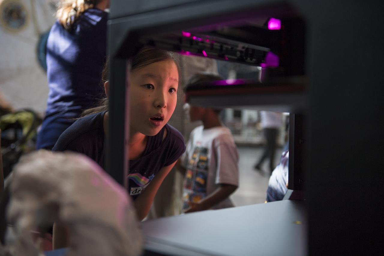A visitor watches as a rocket is printed by a Makerbot 3D printer at a pop-up makerspace held by Future Engineers, with support from NASA and The American Society of Mechanical Engineers (ASME), at the Steven F. Udvar-Hazy Center, Thursday, September 21, 2017 in Chantilly, Virginia. Participants created digital 3D models using Autodesk Tinkercad and watched objects being printed with Makerbot 3D printers. Photo Credit: (NASA/Aubrey Gemignani)