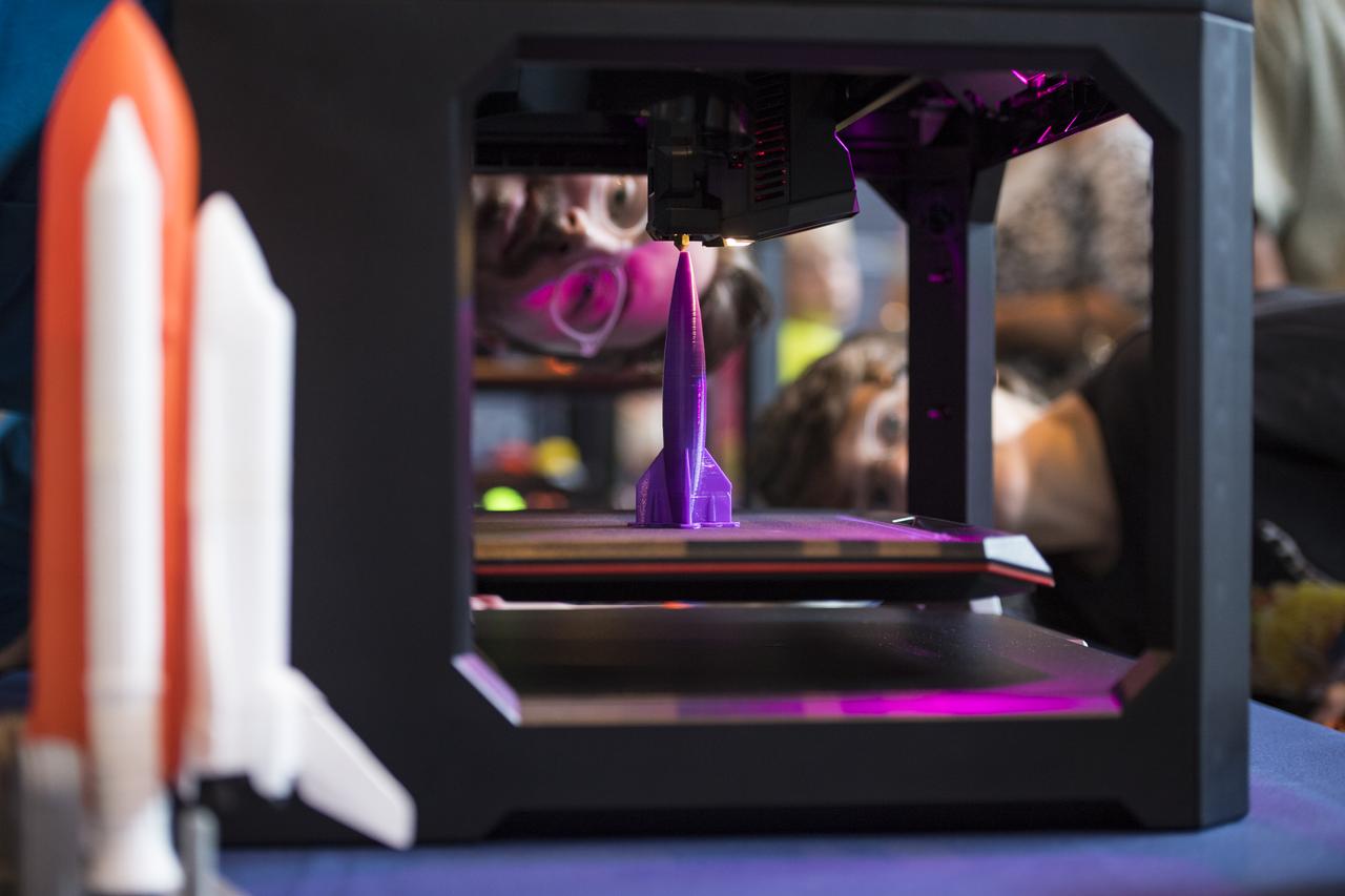 Visitors watch as a rocket is printed by a Makerbot 3D printer at a pop-up makerspace held by Future Engineers, with support from NASA and The American Society of Mechanical Engineers (ASME), at the Steven F. Udvar-Hazy Center, Thursday, September 21, 2017 in Chantilly, Virginia. Participants created digital 3D models using Autodesk Tinkercad and watched objects being printed with Makerbot 3D printers. Photo Credit: (NASA/Aubrey Gemignani)