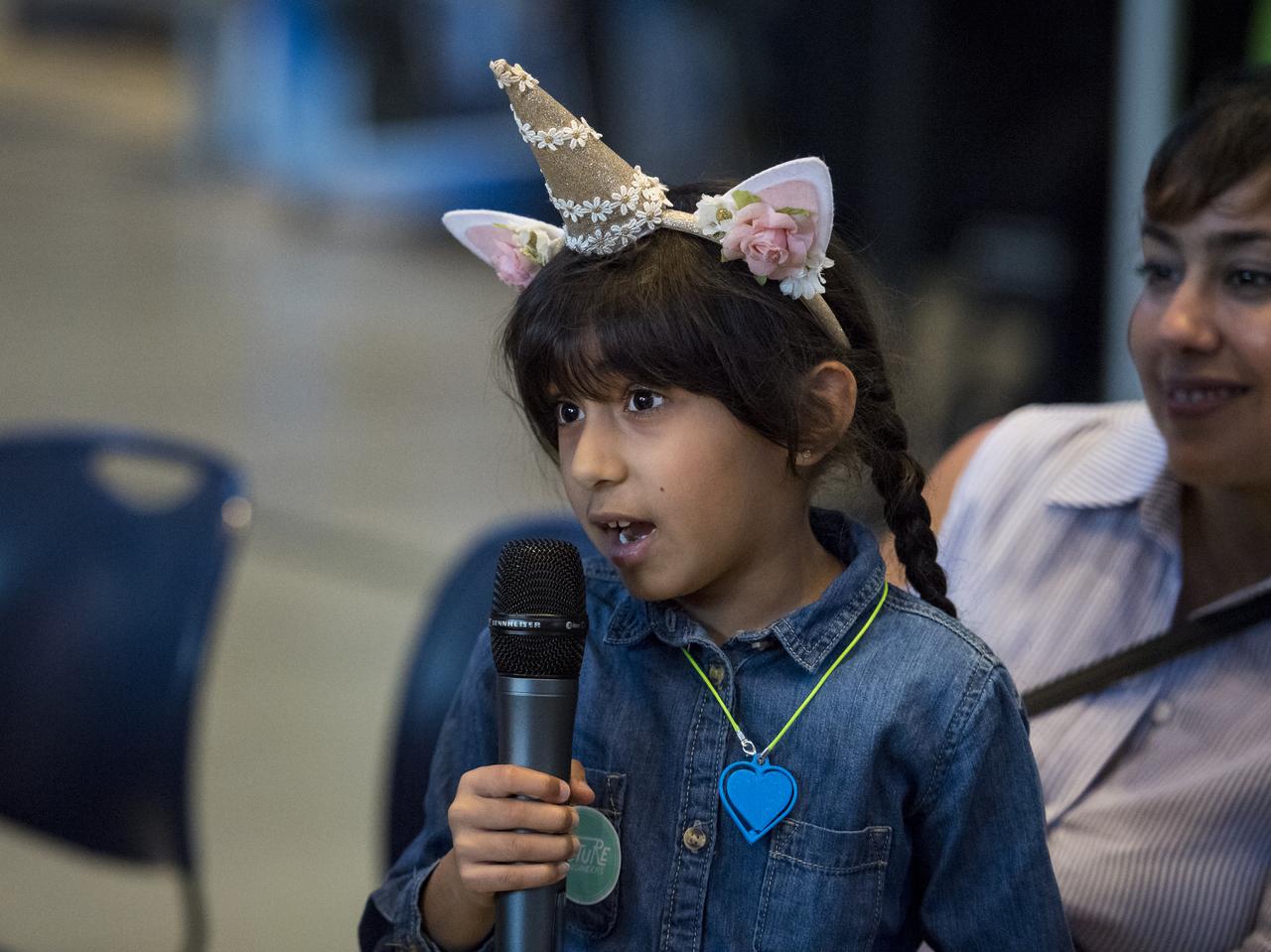 A young audience member asks the panel a question during a discussion on improving air quality for health in space and on Earth, at a pop-up makerspace hosted by Future Engineers with support from NASA and The American Society of Mechanical Engineers (ASME), at the Steven F. Udvar-Hazy Center, Thursday, September 21, 2017 in Chantilly, Virginia. Participants were able to create digital 3D models using Autodesk Tinkercad and watch objects being printed with Makerbot 3D printers. Photo Credit: (NASA/Aubrey Gemignani)