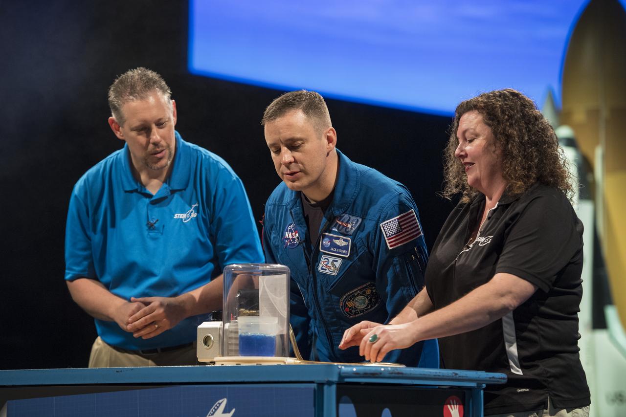 NASA astronaut Jack Fischer conducts an experiment during a Stem in 30 segment, Friday, Nov. 3, 2017 at Smithsonian's National Air and Space Museum in Washington. During Expedition 52, Fischer completed hundreds of scientific experiments and two spacewalks, and concluded his 136-day mission onboard the International Space Station, when he landed in a remote area near the town of Zhezkazgan, Kazakhstan in September 2017. Photo Credit: (NASA/Aubrey Gemignani)