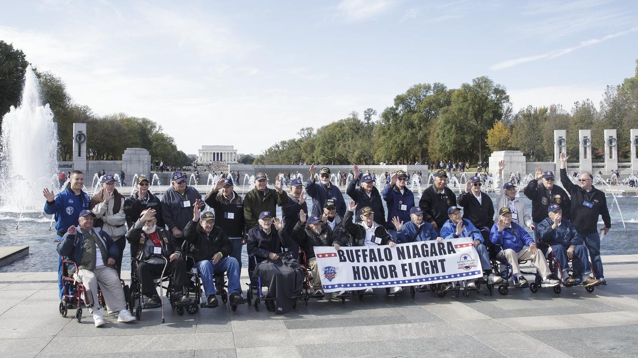 NASA astronaut Jack Fischer poses for a group photo at the World War II Memorial with veterans who traveled to Washington, DC with the Buffalo Niagara Honor Flight, Saturday, Nov. 4, 2017. Photo Credit: (NASA/Joel Kowsky)