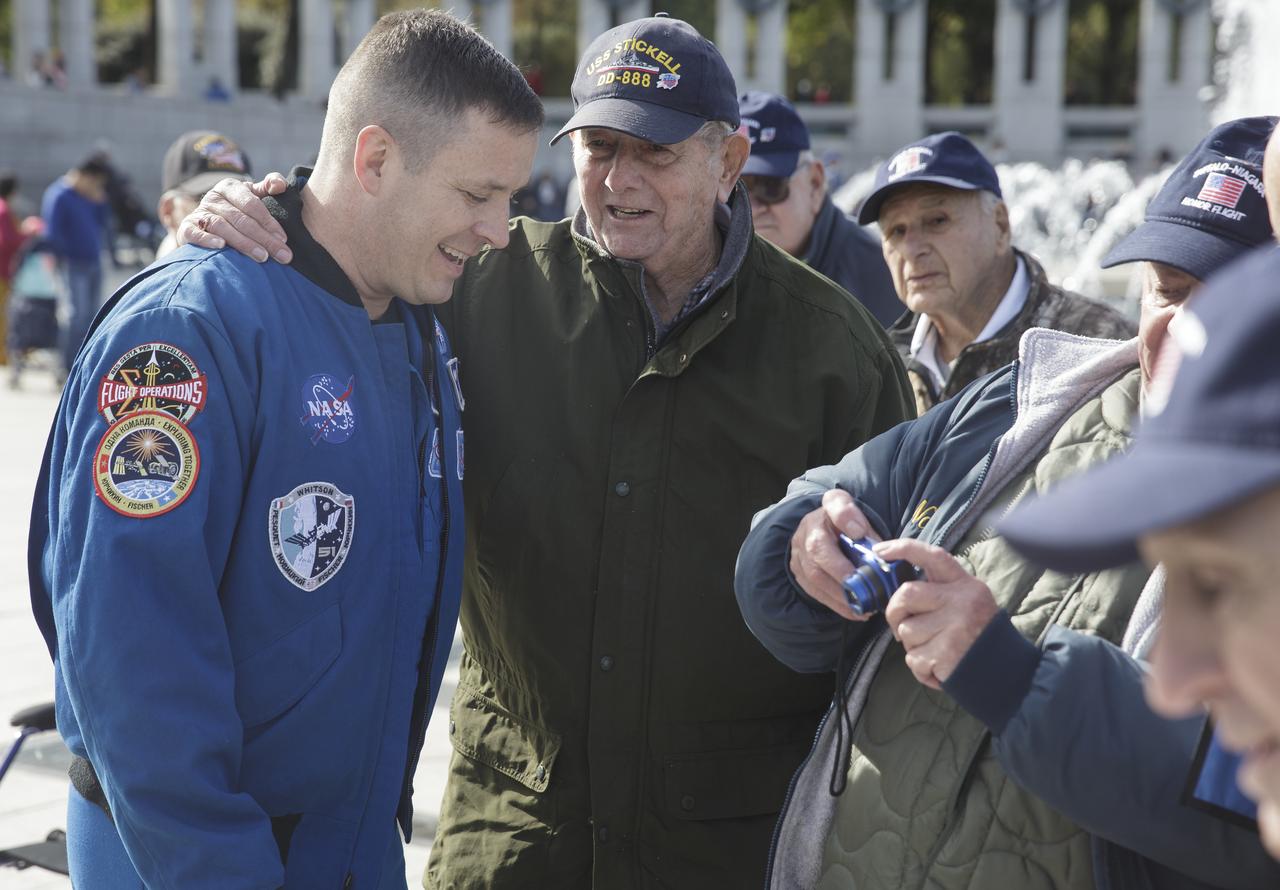 NASA astronaut Jack Fischer talks with veterans at the World War II Memorial who traveled to Washington, DC with the Buffalo Niagara Honor Flight, Saturday, Nov. 4, 2017. Photo Credit: (NASA/Joel Kowsky)