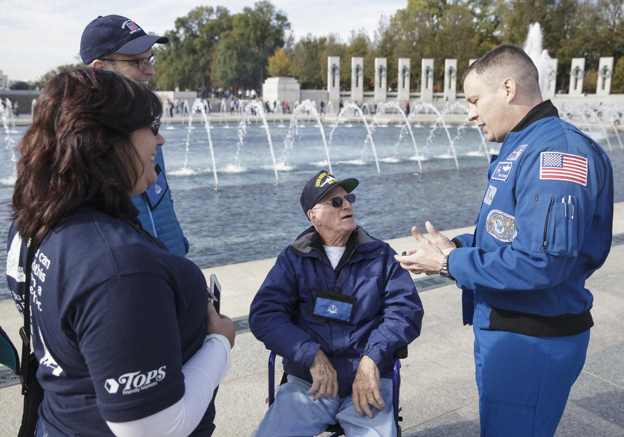 NASA astronaut Jack Fischer talks with veterans at the World War II Memorial who traveled to Washington, DC with the Buffalo Niagara Honor Flight, Saturday, Nov. 4, 2017. Photo Credit: (NASA/Joel Kowsky)