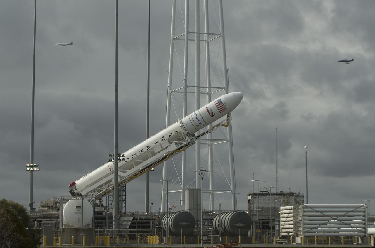 The Orbital ATK Antares rocket, with the Cygnus spacecraft onboard, is raised into the vertical position on launch Pad-0A, Thursday, Nov. 9, 2017 at NASA's Wallops Flight Facility in Virginia. Orbital ATK’s eighth contracted cargo resupply mission with NASA to the International Space Station will deliver over 7,400 pounds of science and research, crew supplies and vehicle hardware to the orbital laboratory and its crew. Photo Credit: (NASA/Bill Ingalls)