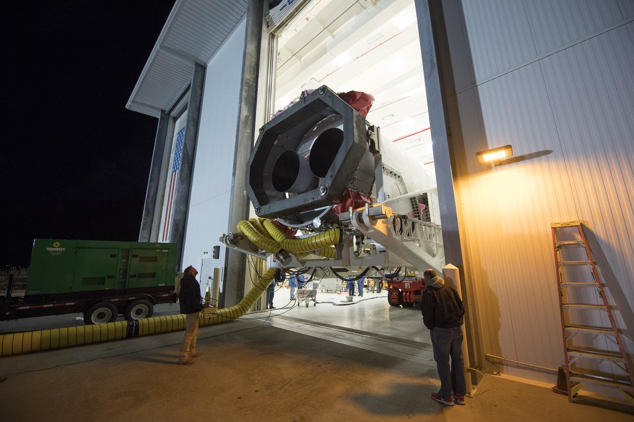 Orbital ATK Mechanical Technician Phil Kauthen drives the transporter with the Antares rocket aboard from the Horizontal Integration Facility to launch Pad-0A, Thursday, Nov. 9, 2017 at NASA's Wallops Flight Facility in Virginia. Orbital ATK’s eighth contracted cargo resupply mission with NASA to the International Space Station will deliver over 7,400 pounds of science and research, crew supplies and vehicle hardware to the orbital laboratory and its crew. Photo Credit: (NASA/Bill Ingalls)