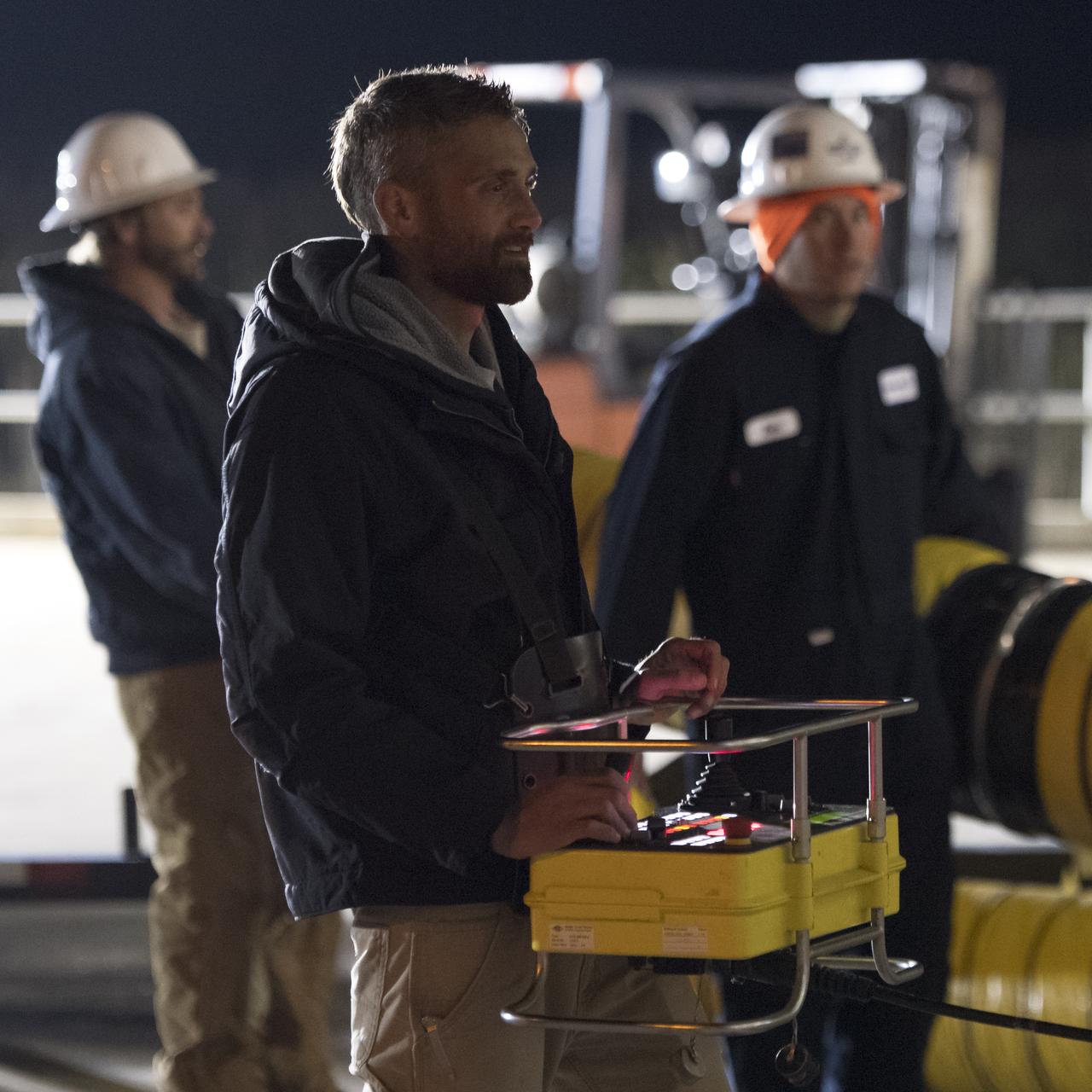 Orbital ATK Mechanical Technician Phil Kauthen drives the transporter with the Antares rocket aboard from the Horizontal Integration Facility to launch Pad-0A, Thursday, Nov. 9, 2017 at NASA's Wallops Flight Facility in Virginia. Orbital ATK’s eighth contracted cargo resupply mission with NASA to the International Space Station will deliver over 7,400 pounds of science and research, crew supplies and vehicle hardware to the orbital laboratory and its crew. Photo Credit: (NASA/Bill Ingalls)